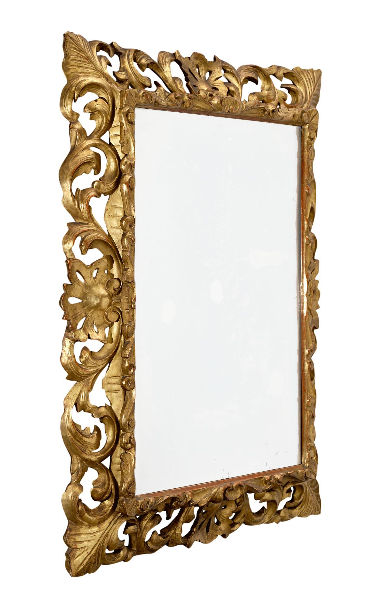 Napoleon III mirror from France made of solid hand-carved oak that has been finished with 24 carat gold leaf. The mercury mirror is original and beveled. This piece is striking and has great impact on a space.