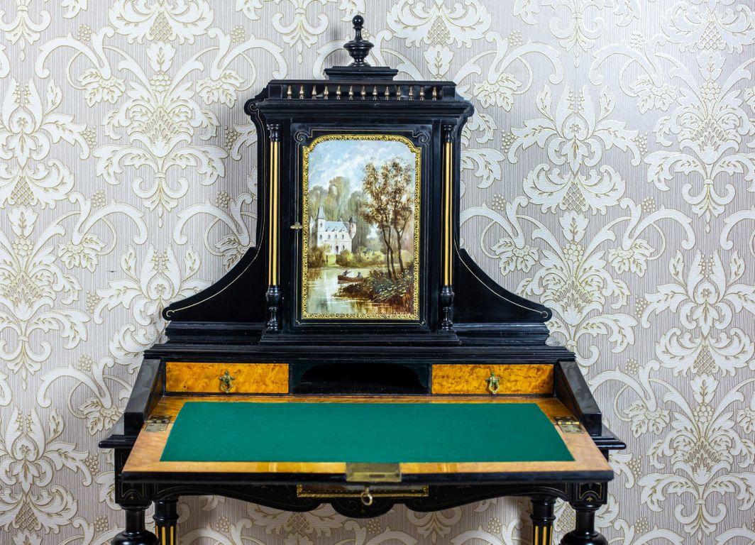 We present you this unique antique piece of furniture, circa 1870; with a lid closed from the front, which forms a writing surface after it is dropped down, a wide drawer under the top, and a removable add-on unit in the form of a cabinet, which is