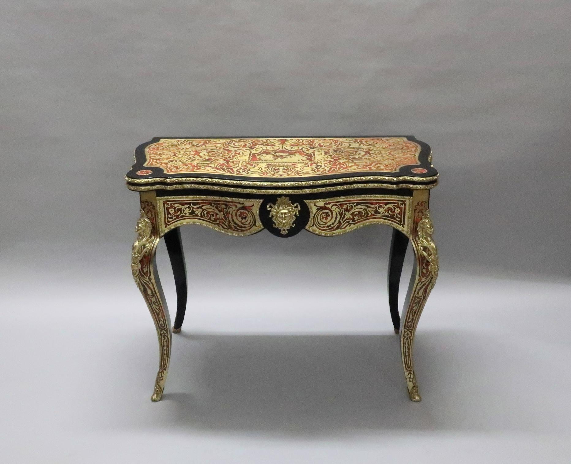 An extremely good quality French Napoleon III freestanding serpentine shaped fold over games or occasional table in the Louis XV style. The table is inlaid with engraved brass and red tortoise shell and is stood on square tapering cabriole legs. The