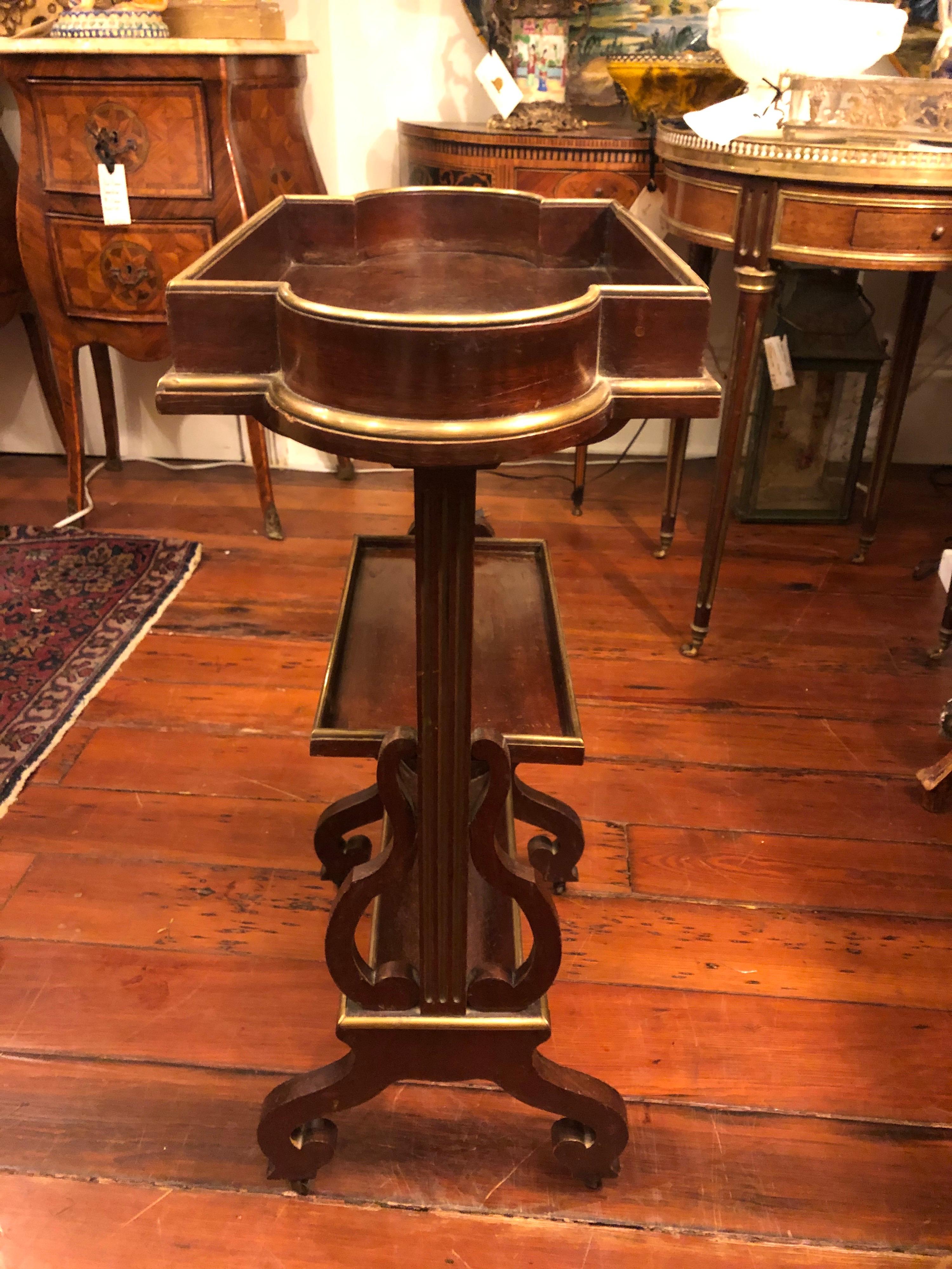 Small French Napoleon III occasional table with three surfaces two flat and one curved. Mahogany with brass edging.