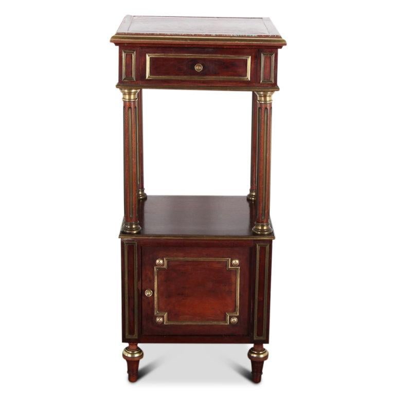 A French Napoleon III nightstand, the upper section with drawer and marble top and raised on fluted columns above a small cabinet. Accented with brass trim throughout, circa 1875.



