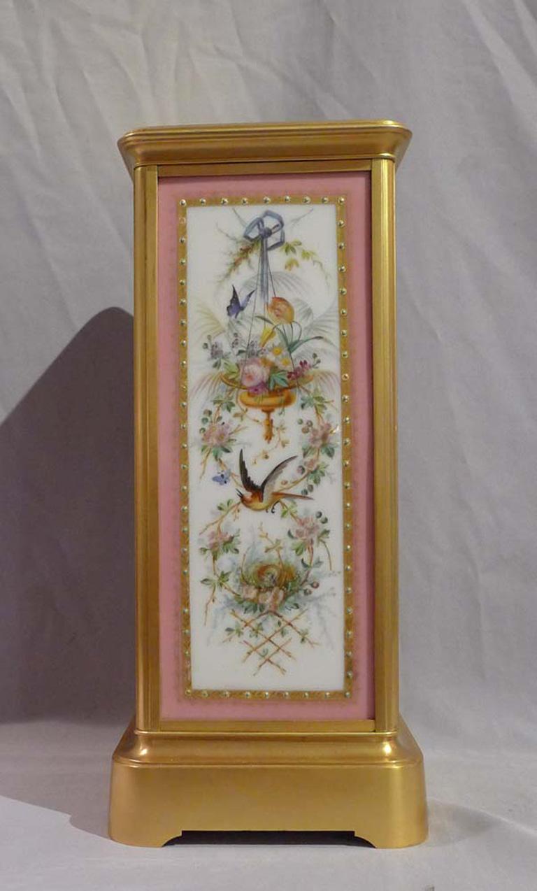 French Napoleon III ormolu and porcelain sided mantel clock in four glass form. The clock has fine jewelled porcelain panels on three sides including the full size dial. The porcelain has a pink ground and to the front a beautifully decorated dial