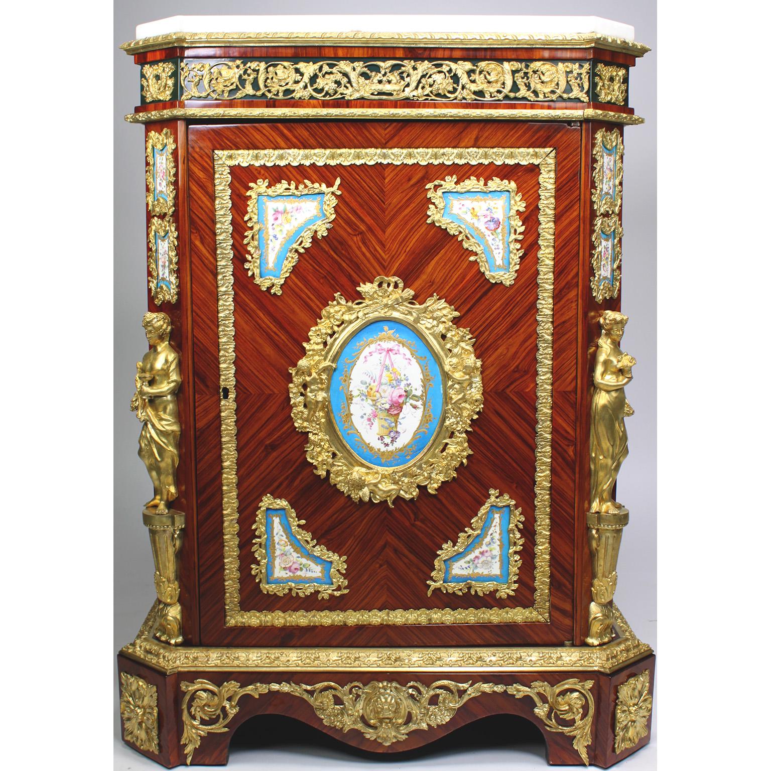 A Very Fine French Napoleon III Figural Ormolu and Porcelain (Probably Sevres) Mounted Tulipwood Meuble A Hauteur D'Appui, by Mathieu Befort, dit Befort Jeune. The rectangular shaped body fitted with a white marble top on with a reticulated frieze