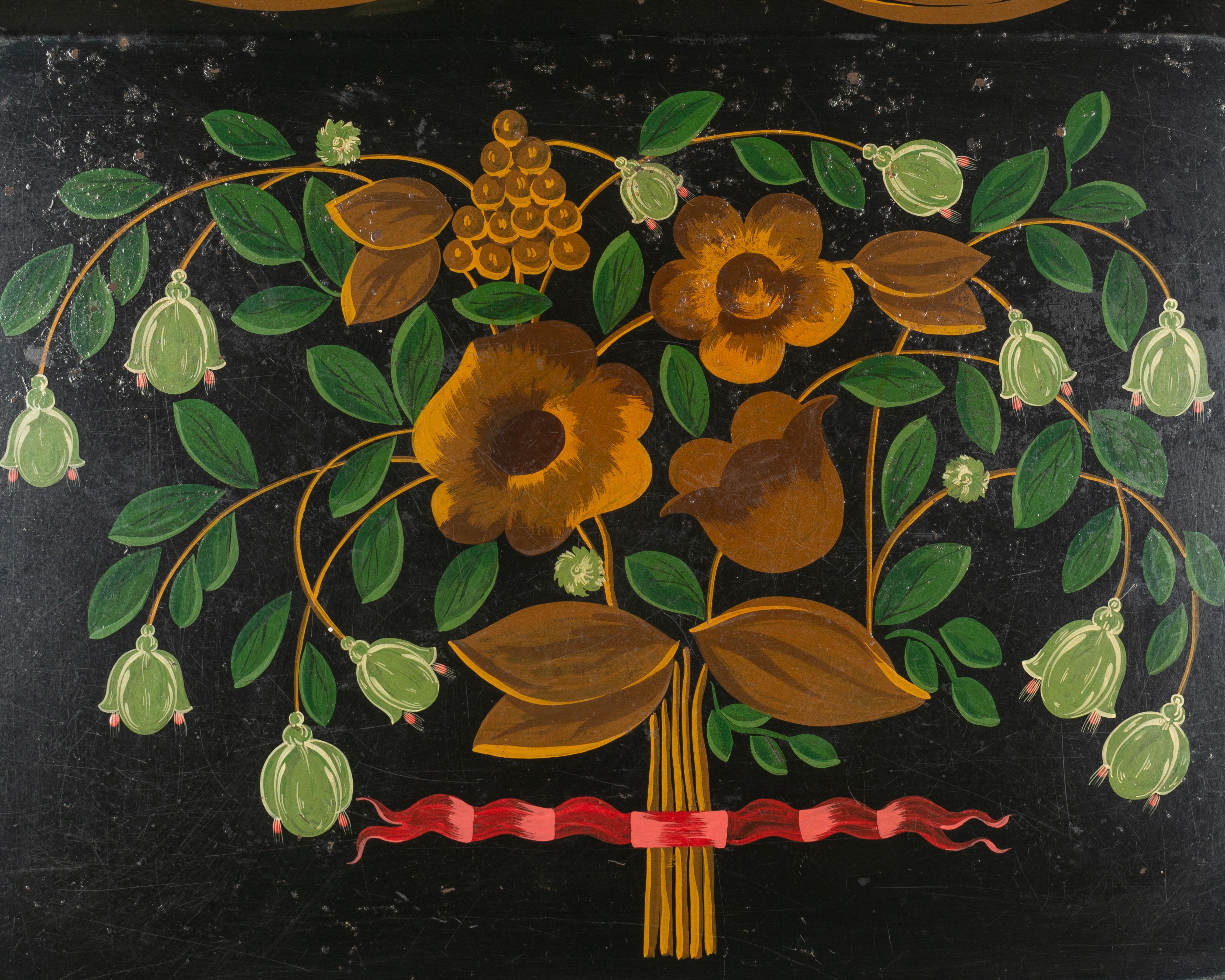 A 19th century French Napoleon III large handled tole serving tray with colorful hand painted floral bouquet in orange and green tied with a red ribbon on a black ground. Felted on the bottom. In good condition considering the age.
