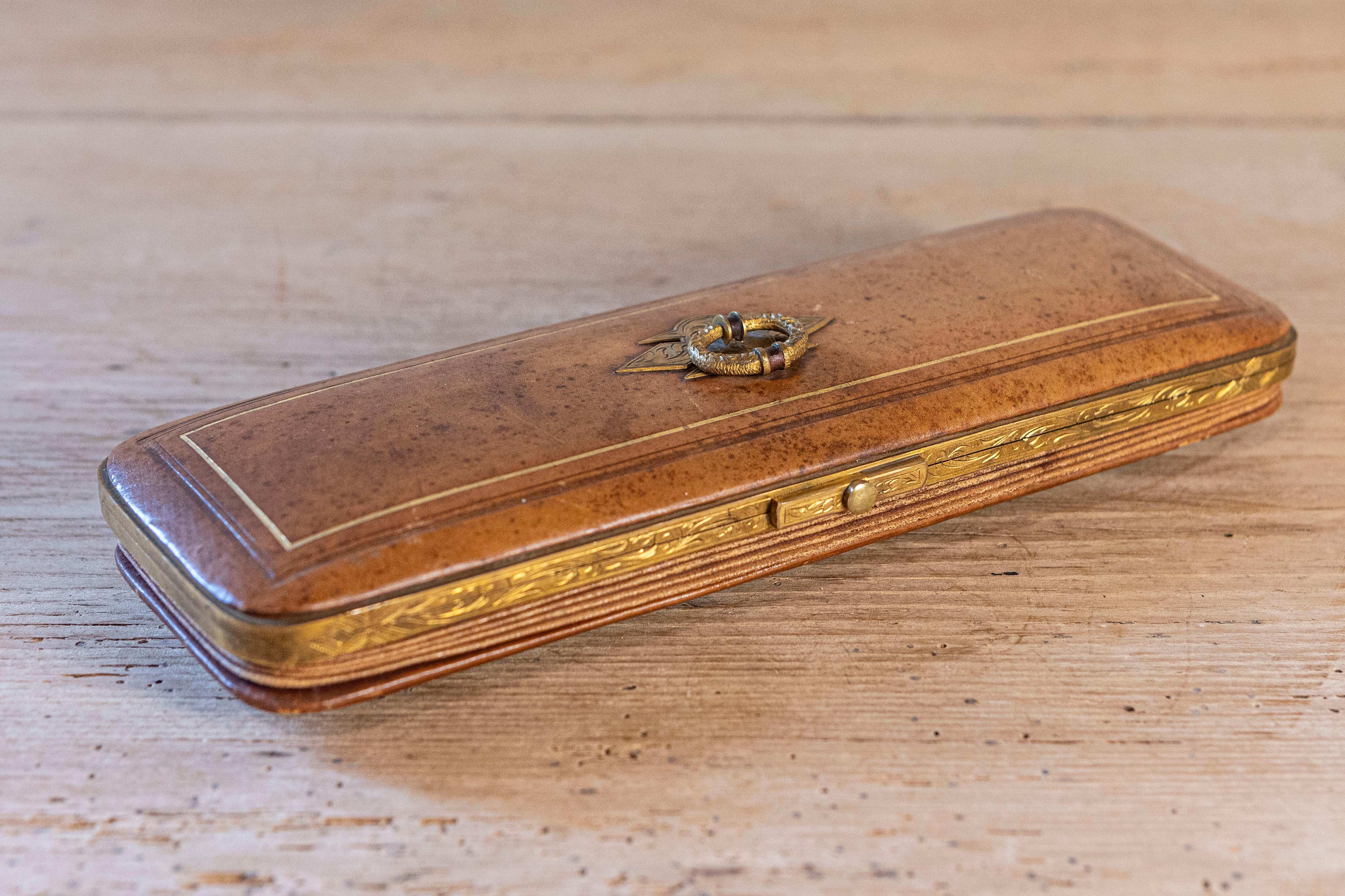 French 1850s Napoléon III period leather case sewing kit with bronze hardware and blue velvet interior. Take a step back into the lavish world of the mid-19th century with this French Napoleon III period sewing kit. This exquisite sewing kit exudes