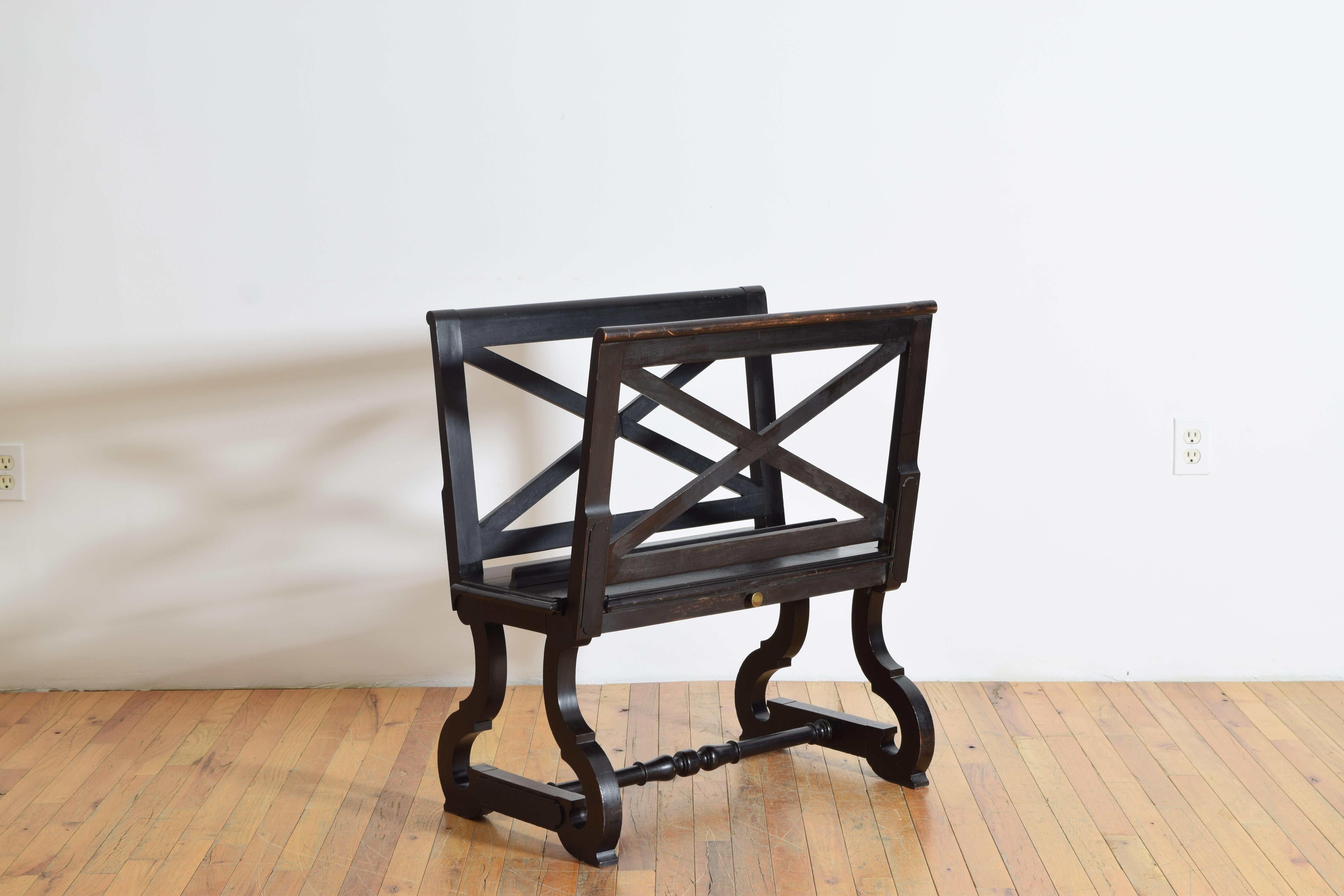 Having two raised sides with x-form panels, one adjustable on a ratchet, the upper area used for portfolios or rolled documents, raised on baroque inspired trestle-form legs joined by a turned stretcher