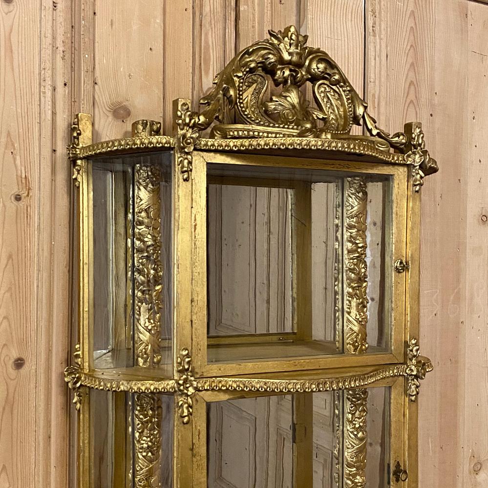 French Napoleon III period giltwood wall vitrine or cabinet is a magnificent example of craftsmanship and artisanry unto itself, although it was designed to showcase particular valuable collectibles. Mirrored in the back as it was made before