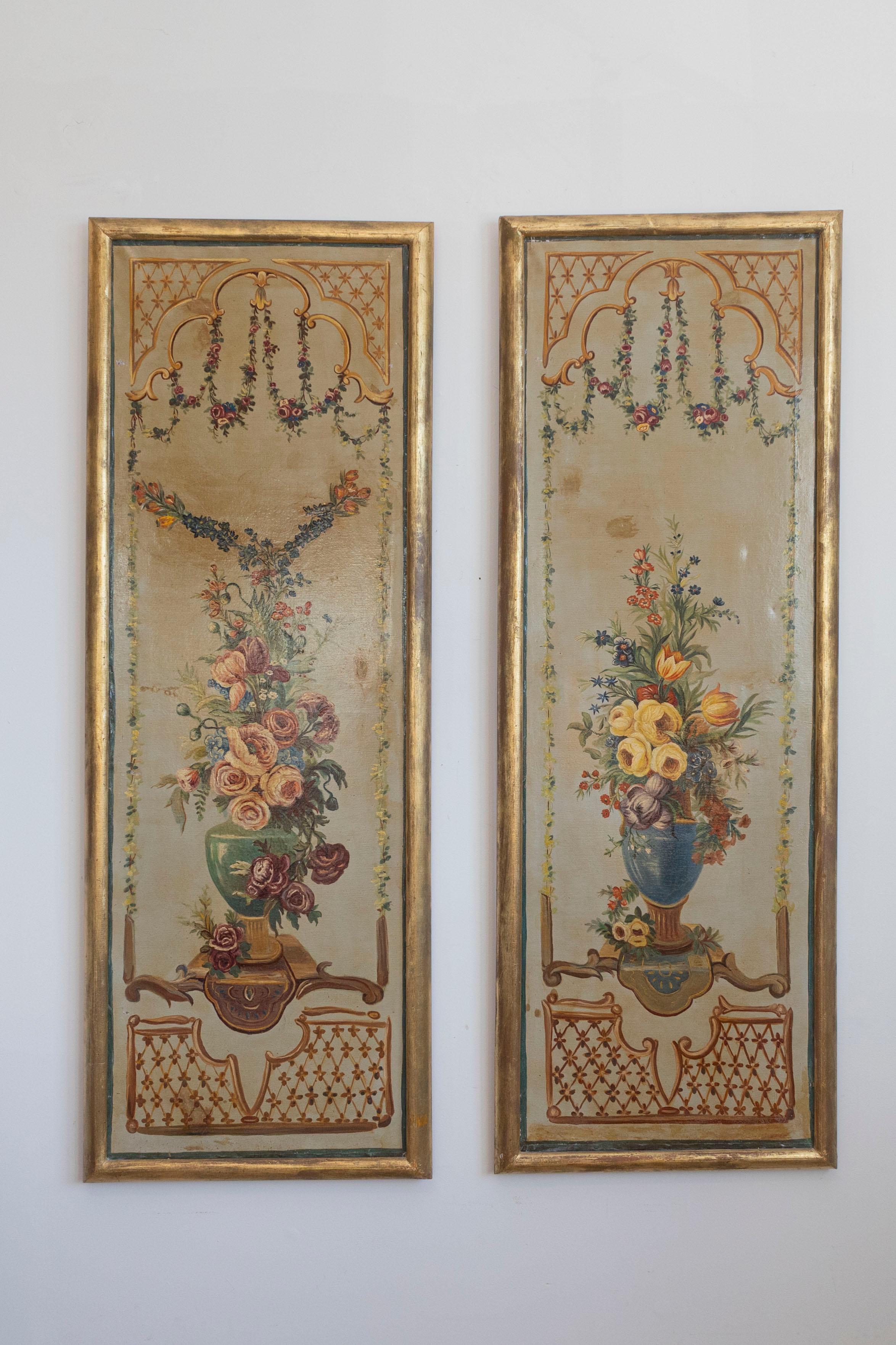 A pair of French Napoleon III period painted decorative panels with floral motifs from the mid-19th century, set inside giltwood frames. Each of this pair of decorative panels features an exquisite décor made of colorful bouquets displayed in green