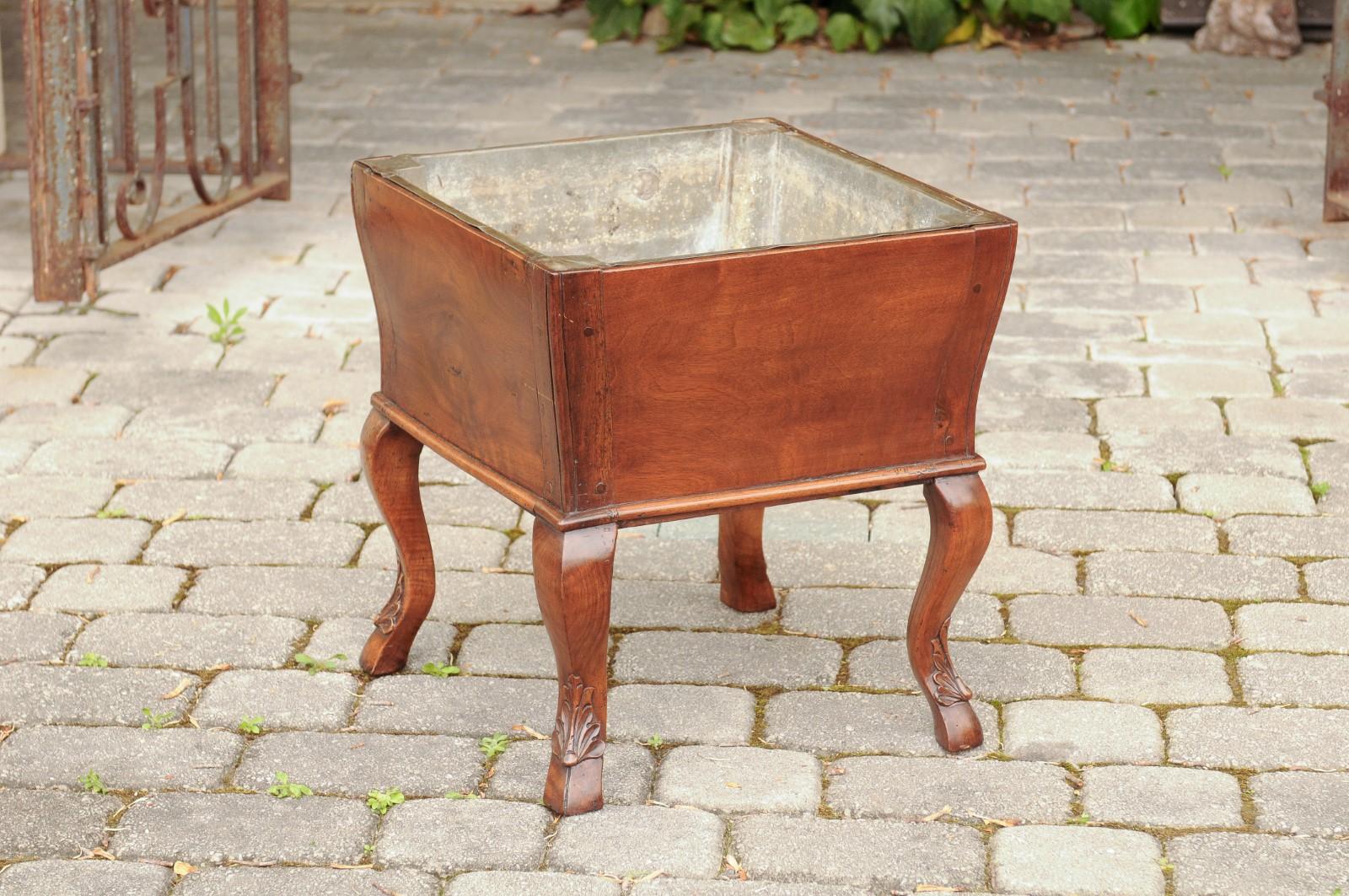 A French Napoleon III period walnut planter from the mid-19th century, with tin-lined interior and cabriole legs. Born in France in the early years of Emperor Napoleon III's reign, this charming walnut planter features a square tin-lined tapering