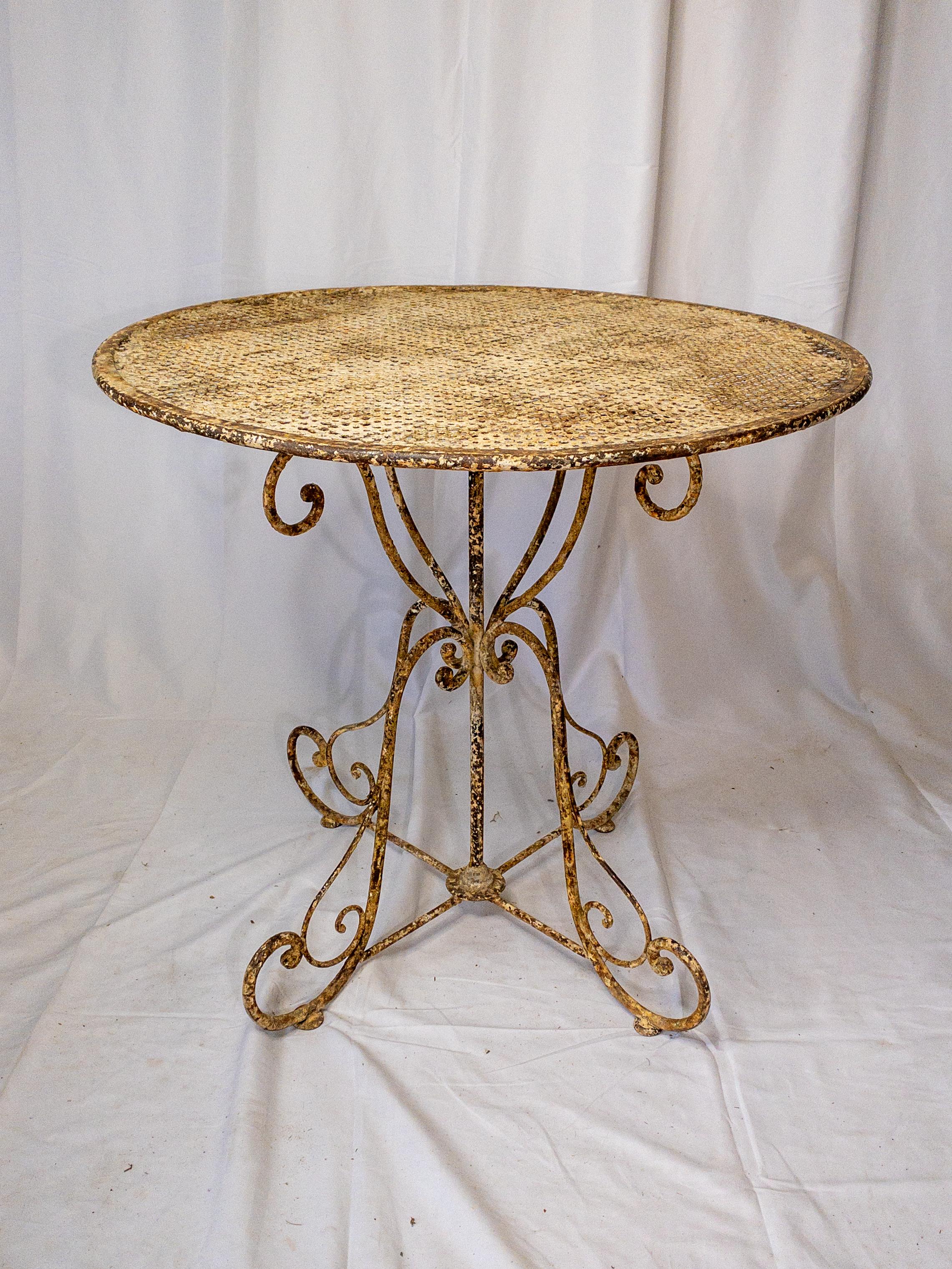 The French Napoleon III period wrought iron garden table exudes timeless charm with its elegant design and rustic allure. Crafted during a period known for its opulence and innovation, this round table showcases intricate wrought iron work,