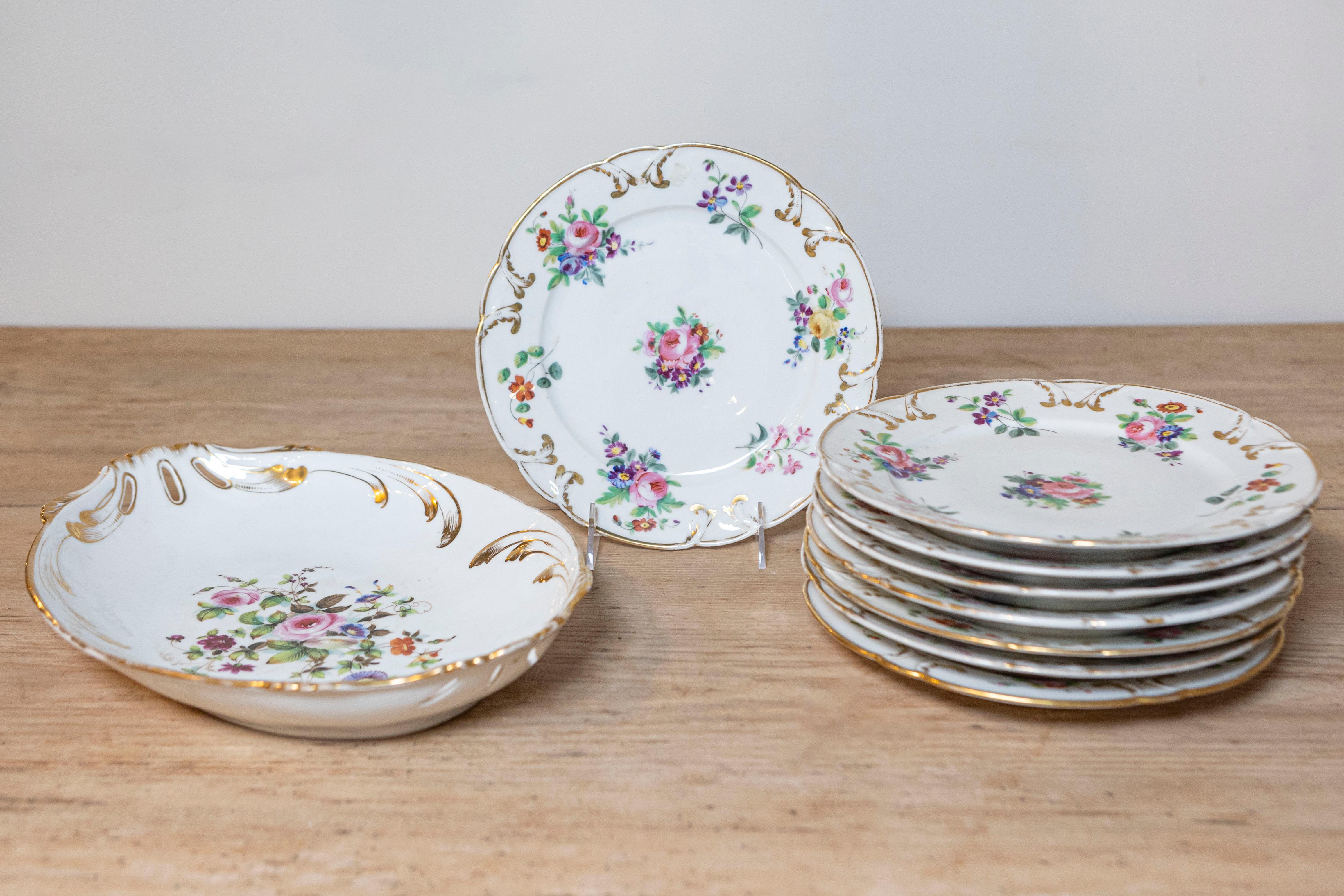 French Napoléon III period Porcelaine de Paris plates from the late 19th century, with floral décor. The plates are sold individually $145 each, the large platter is priced $225. Created in France during the third quarter of the 19th century at the