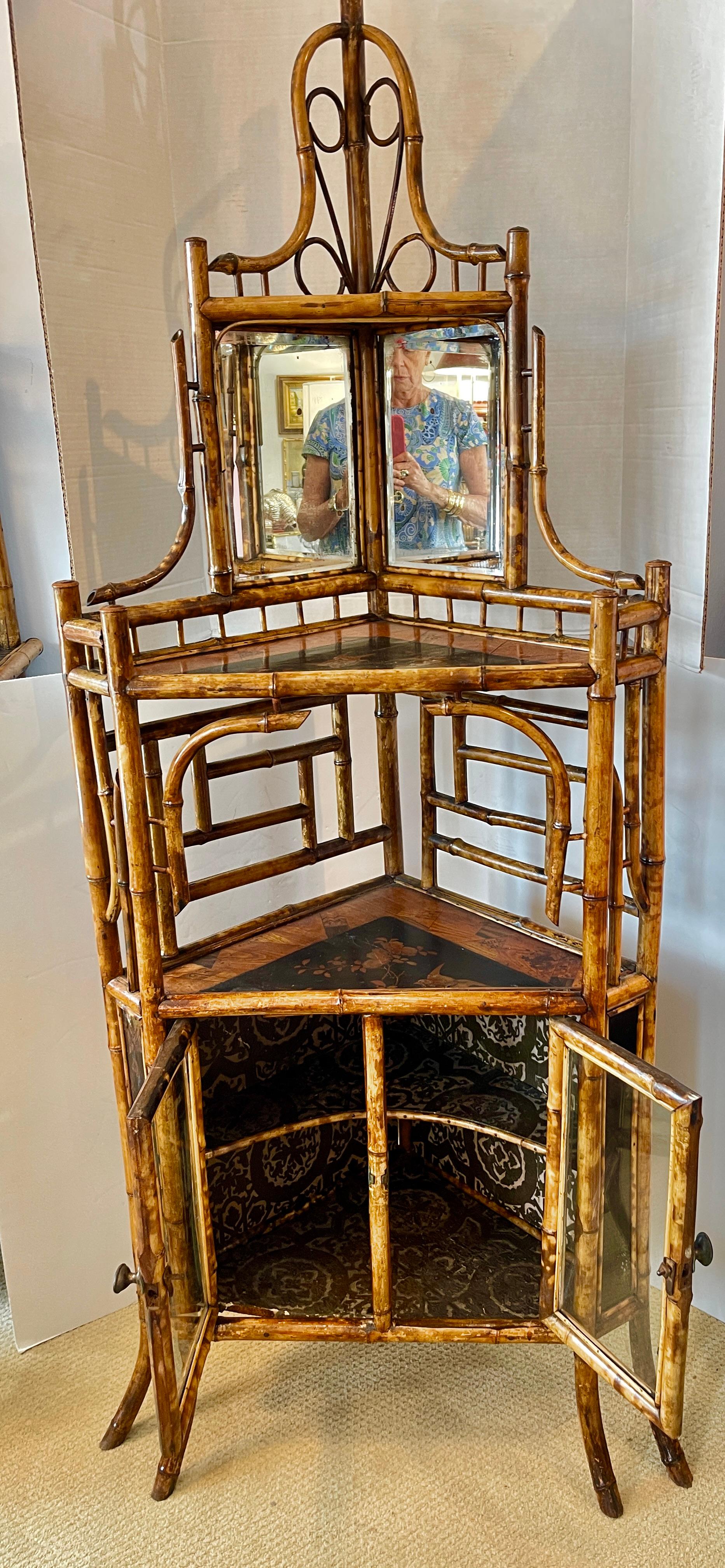 Just in this exceptional French Napoleon III Rare Bamboo & Lacquer Corner Cabinet, C.1870-1890.
This corner cabinet las three shelves with Asian decor at the top and two shelves in the bottom part with original glass and Bamboo doors.
Many intricate