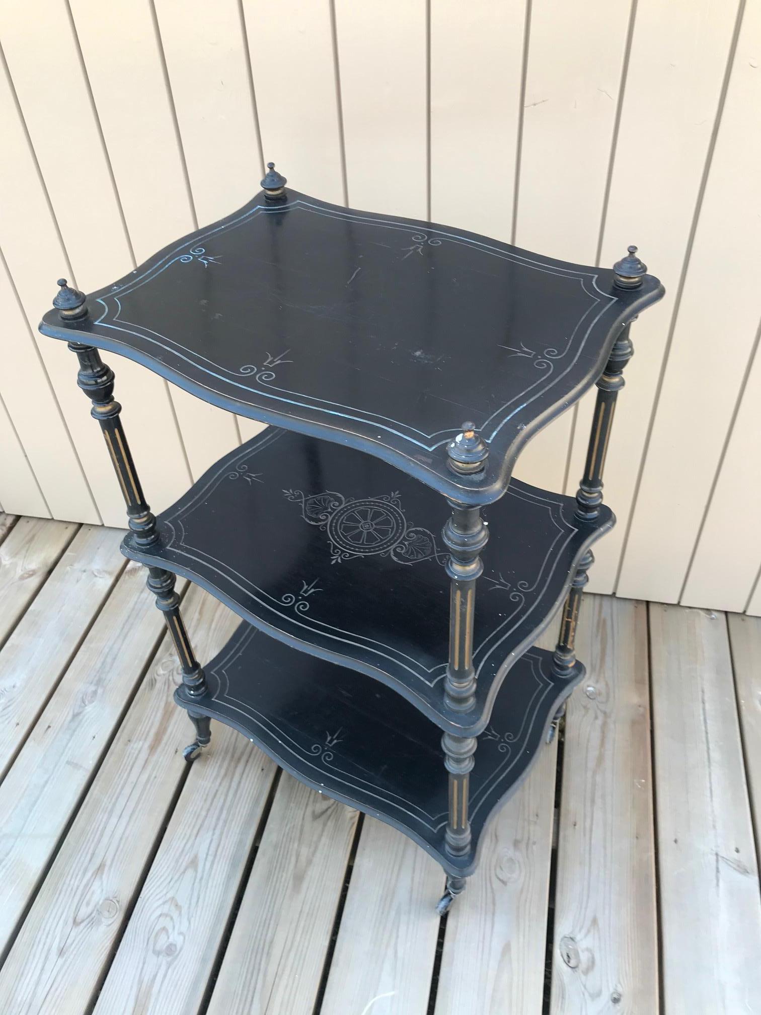 Very nice French Napoleon III rolling serving table made in blackened pear wood.
Beautiful hand graved details on each level on the table.
Four wheels. Good quality.