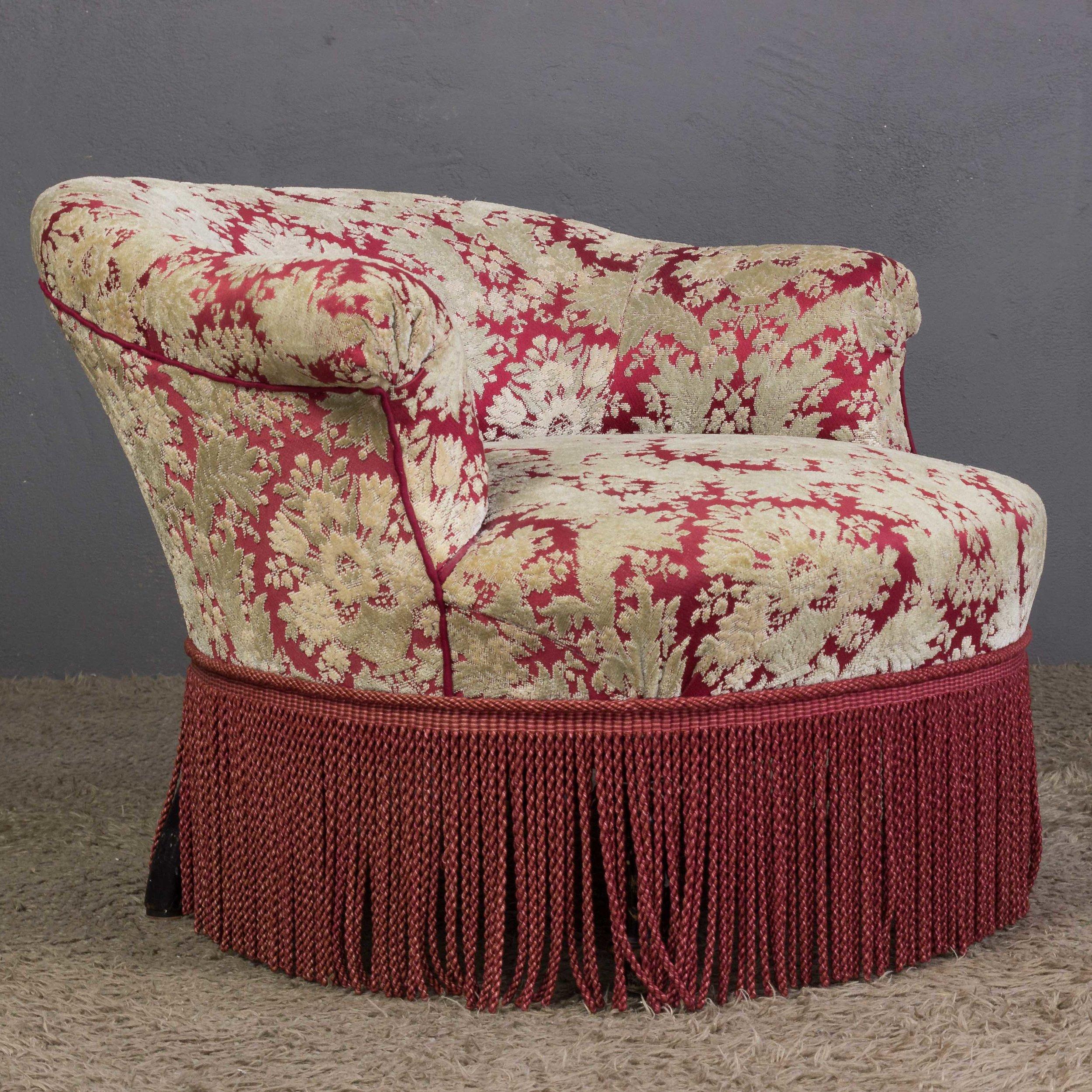 A stunning French Napoleon III slipper chair. This slipper chair is a truly unique piece, with its vintage floral fabric and bullion fringe providing an eye-catching contrast. In good vintage condition, this chair is sure to be a statement piece in