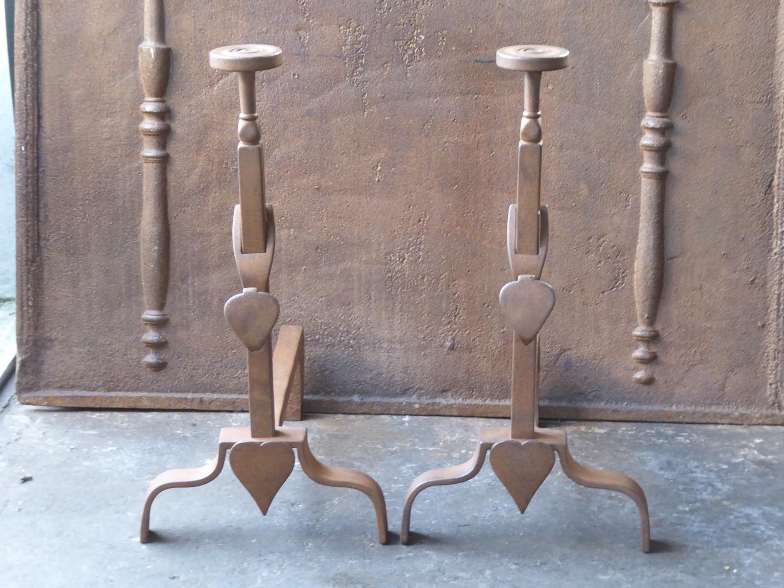 19th-20th century French Napoleon III style andirons. The andirons are made or wrought iron and have a natural brown patina.







