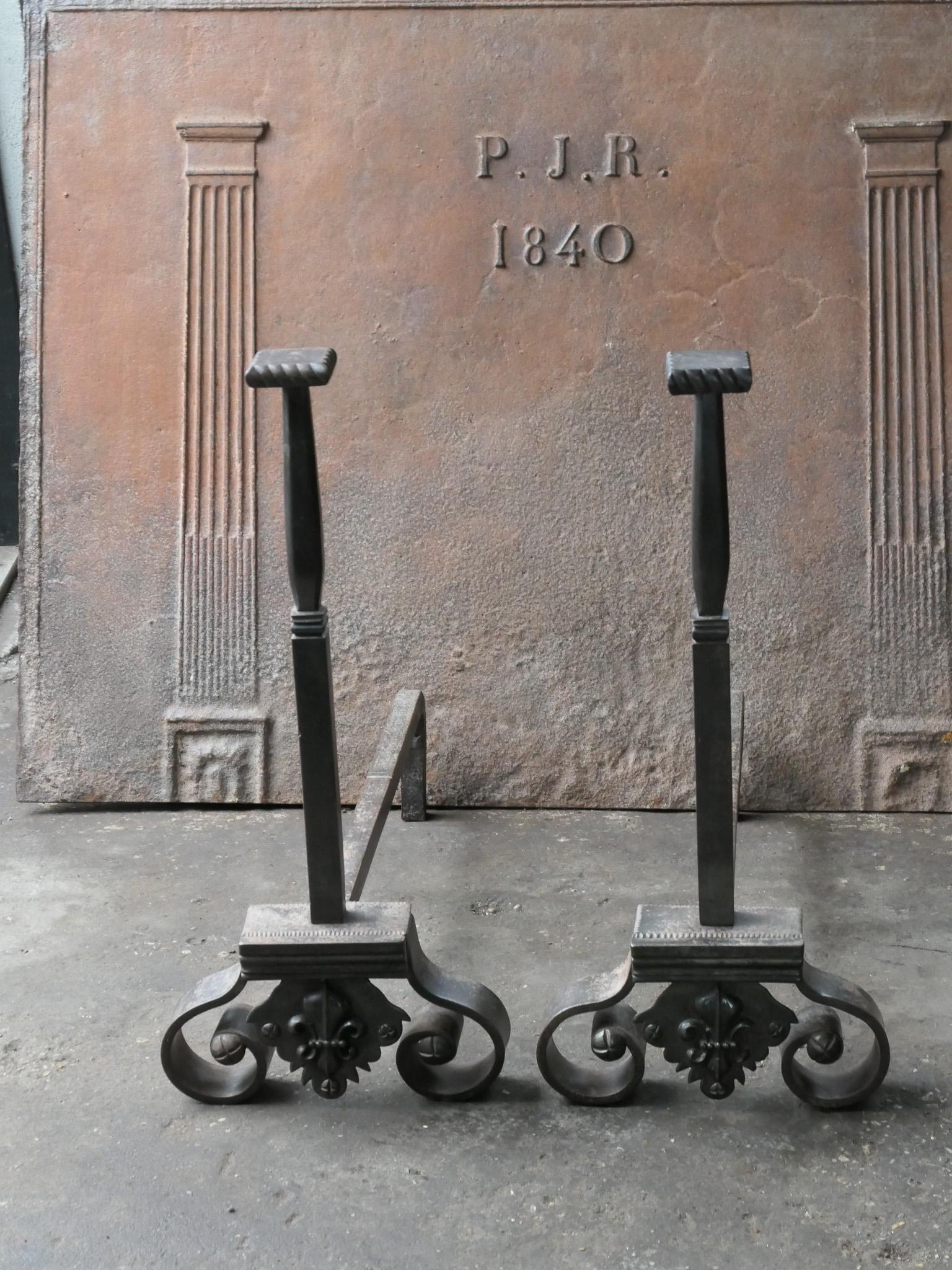 19th-20th century French Napoleon III style andirons made of wrought iron. 

The andirons are in good condition and fit for use in the fireplace.

This product has to be shipped as freight due to its size and/or (volumetric) weight. You can contact