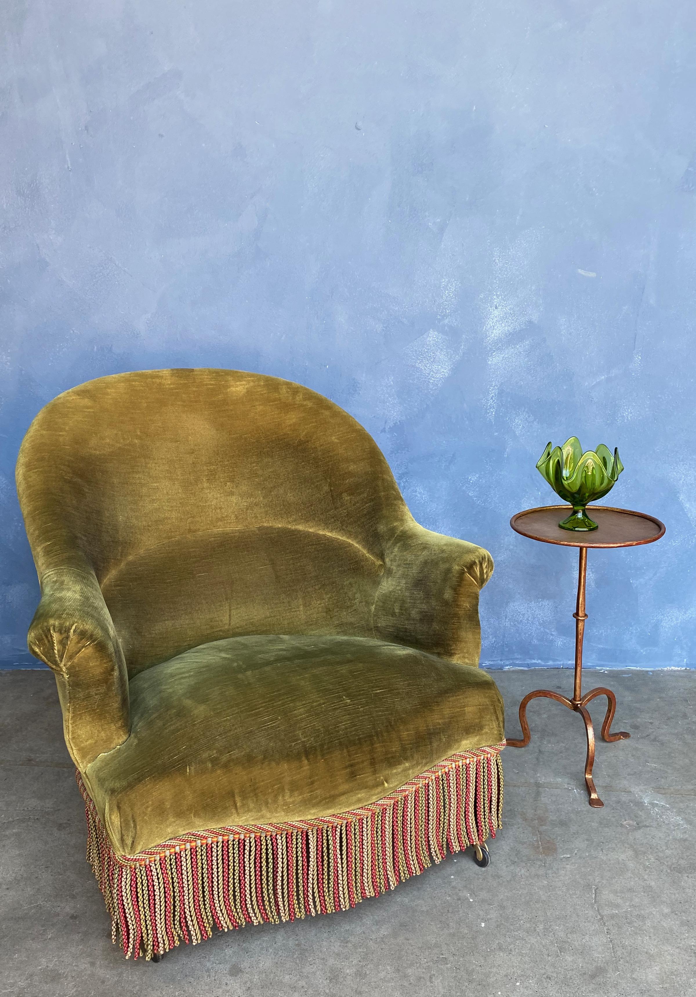 French Napoleon III style armchair in green velvet with bullion fringe. The chair is very comfortable, we have added new casters on the front legs to allow for a relaxed pitch. We have a similar chair that would make for a “faux “ pair, please refer