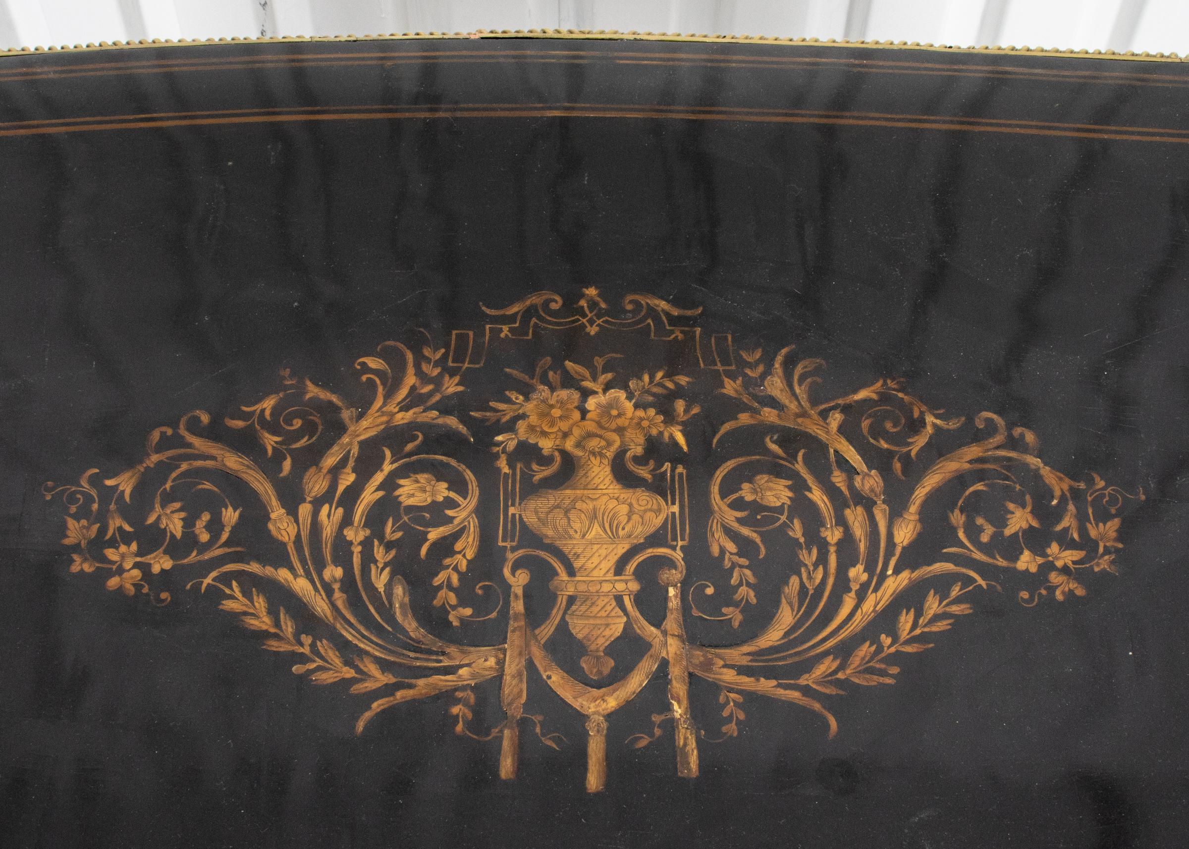 Napoleon III style ebonized bureau plat, the desk with foliate decoration to the top within striped borders above a single long drawer, overall with gilt bronze and gilt metal mounts on cabriole legs. 30” H x 50” W x 27.5” D. Provenance: Removed