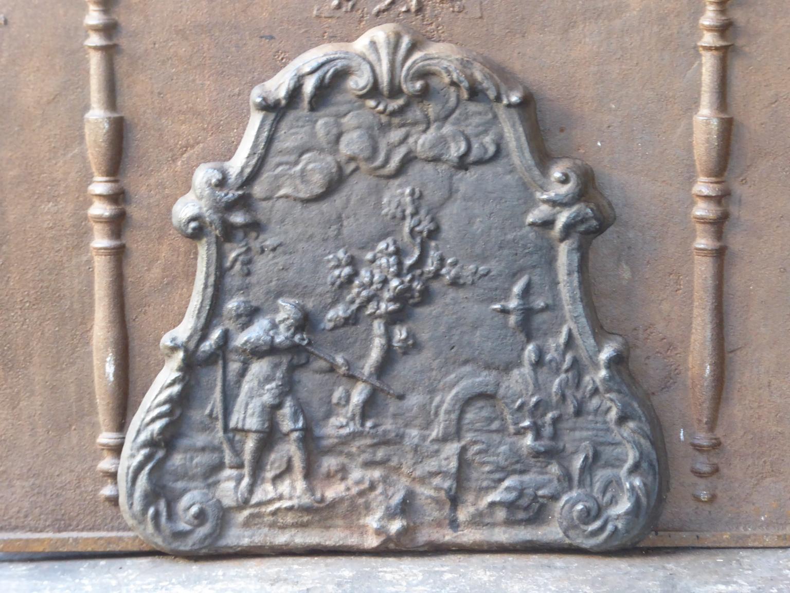 20th century French Napoleon III style fireback with a hunting scene. The fireback is made of cast iron. The patina is natural brown. Upon request it can be made black / pewter.
