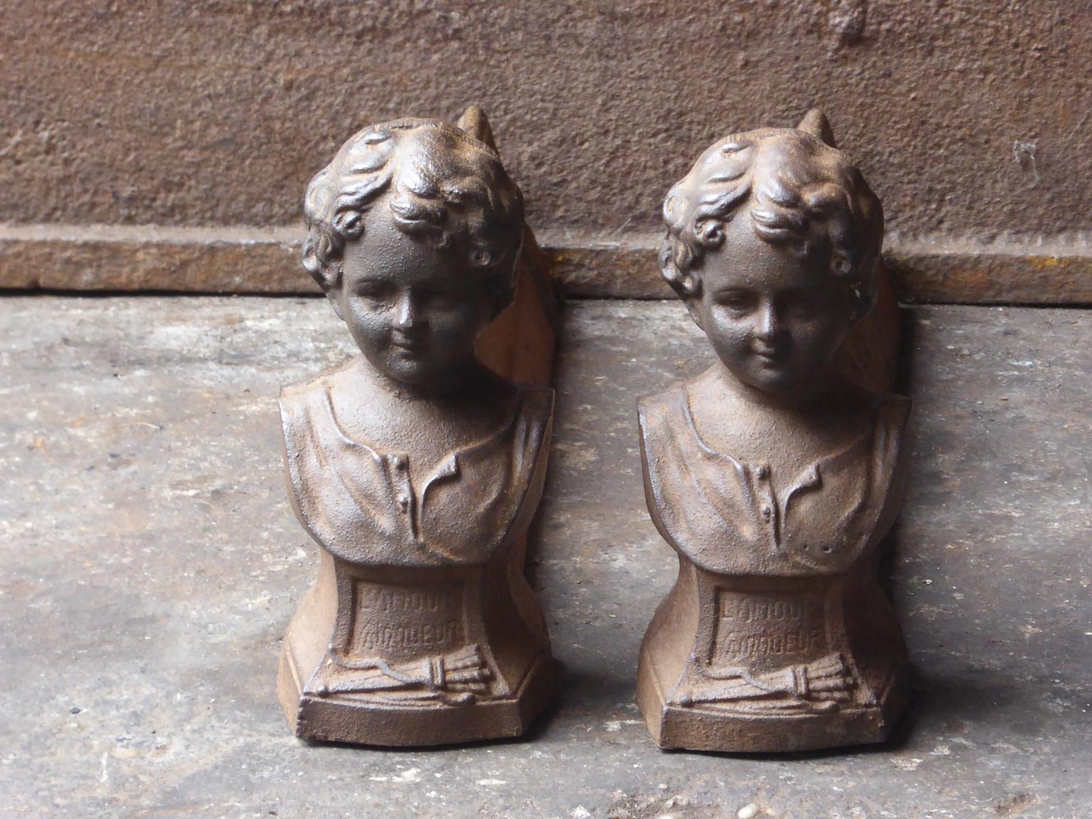 20th century French Napoleon III style 'L'Amour Vainqueur' andirons made of cast iron. The andirons have a natural brown patina. Upon request it can be made black / pewter.