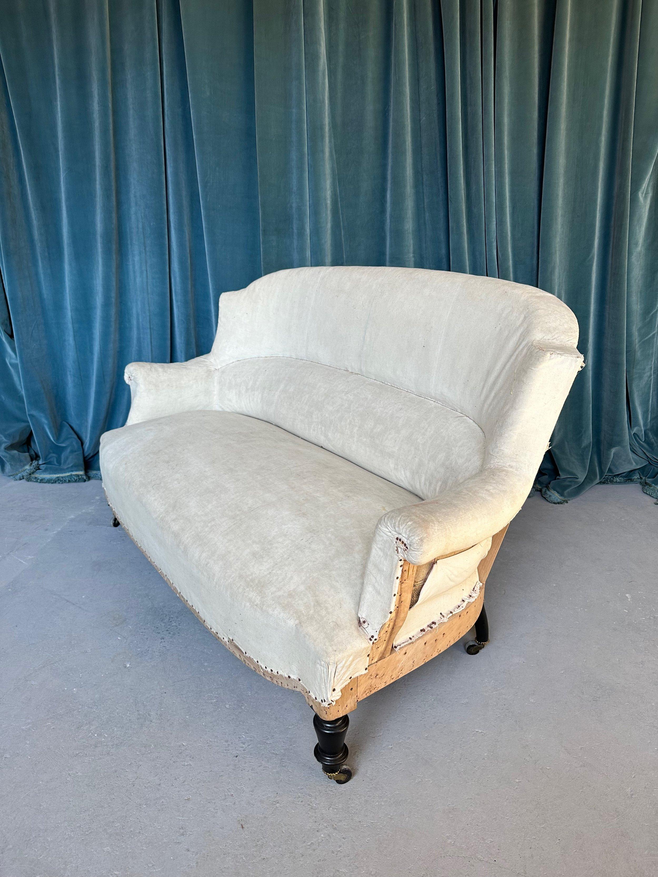 A handsome small French sofa or settee in the Napoleon III style. The classic “chapeau de gendarme“ shape of the back balances perfectly with the gentle curves of the sofa. With the built in lumbar support, the settee is not only elegant in design