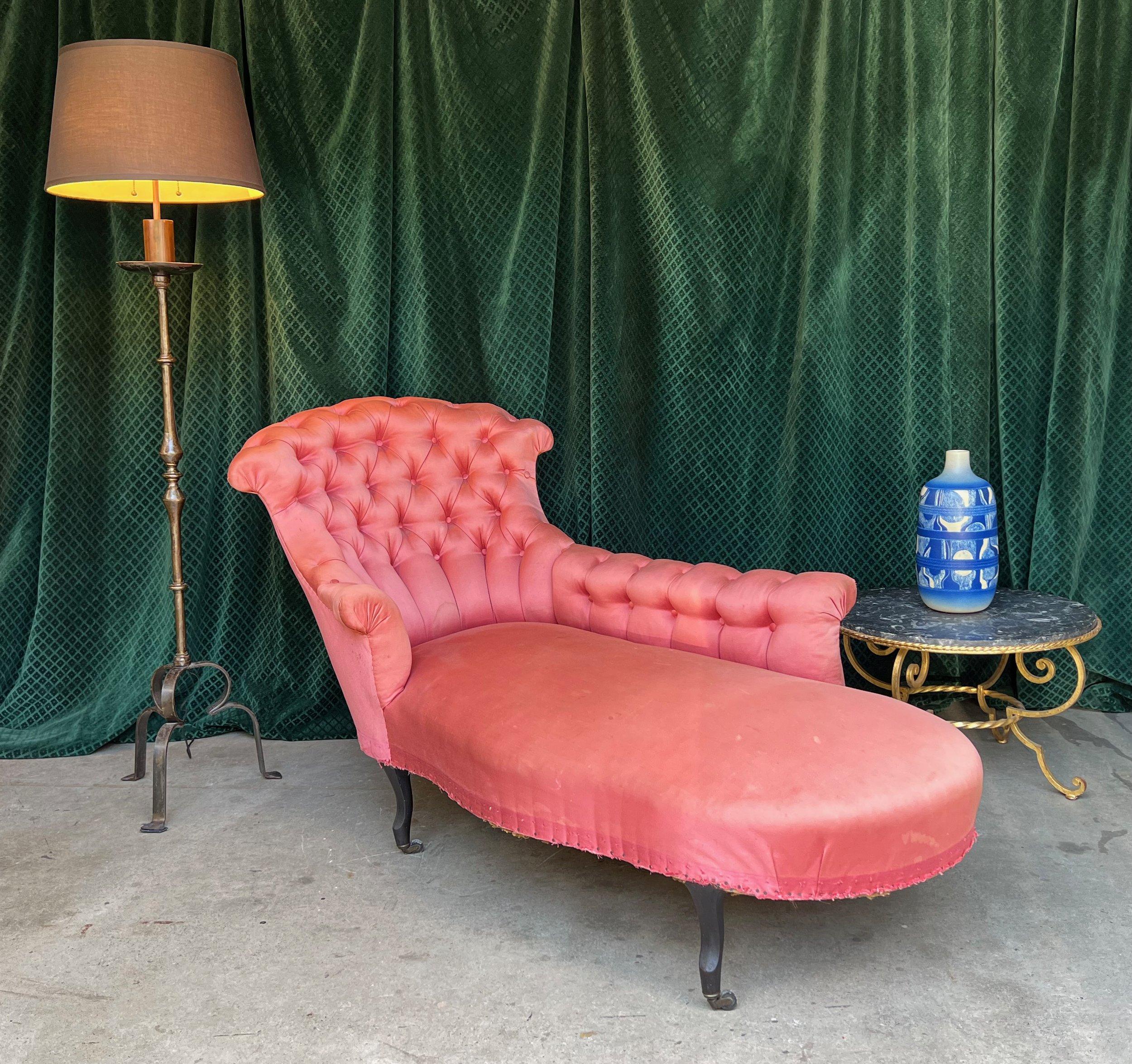 This unique French 19th century Napoleon III tufted chaise lounge merges conventional design with chic, unusual period features. The extended left arm and tight seat, along with the heavily tufted inside back and arms, make this piece a standout