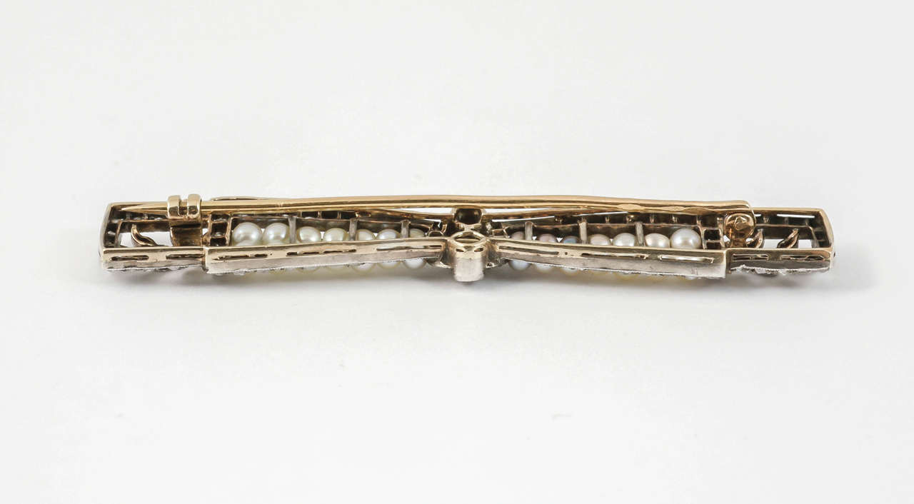 Round Cut Bow Brooch with Diamonds & Natural Pearls in Platinum, French circa 1910 For Sale