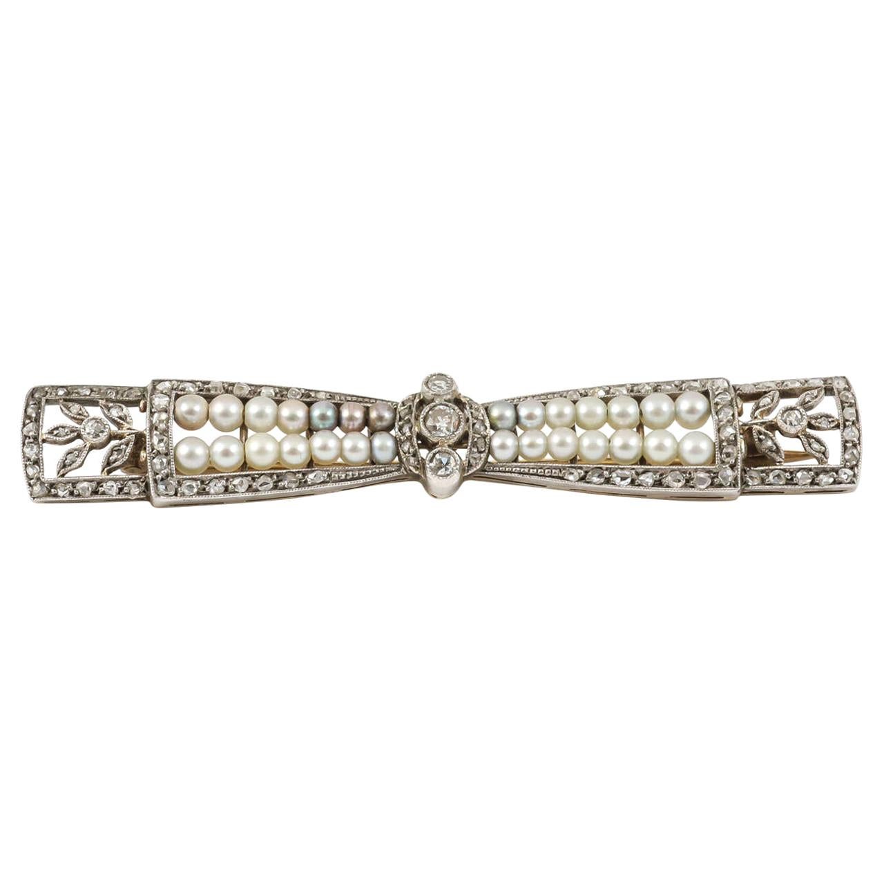 Bow Brooch with Diamonds & Natural Pearls in Platinum, French circa 1910 For Sale