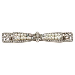 Bow Brooch with Diamonds & Natural Pearls in Platinum, French circa 1910