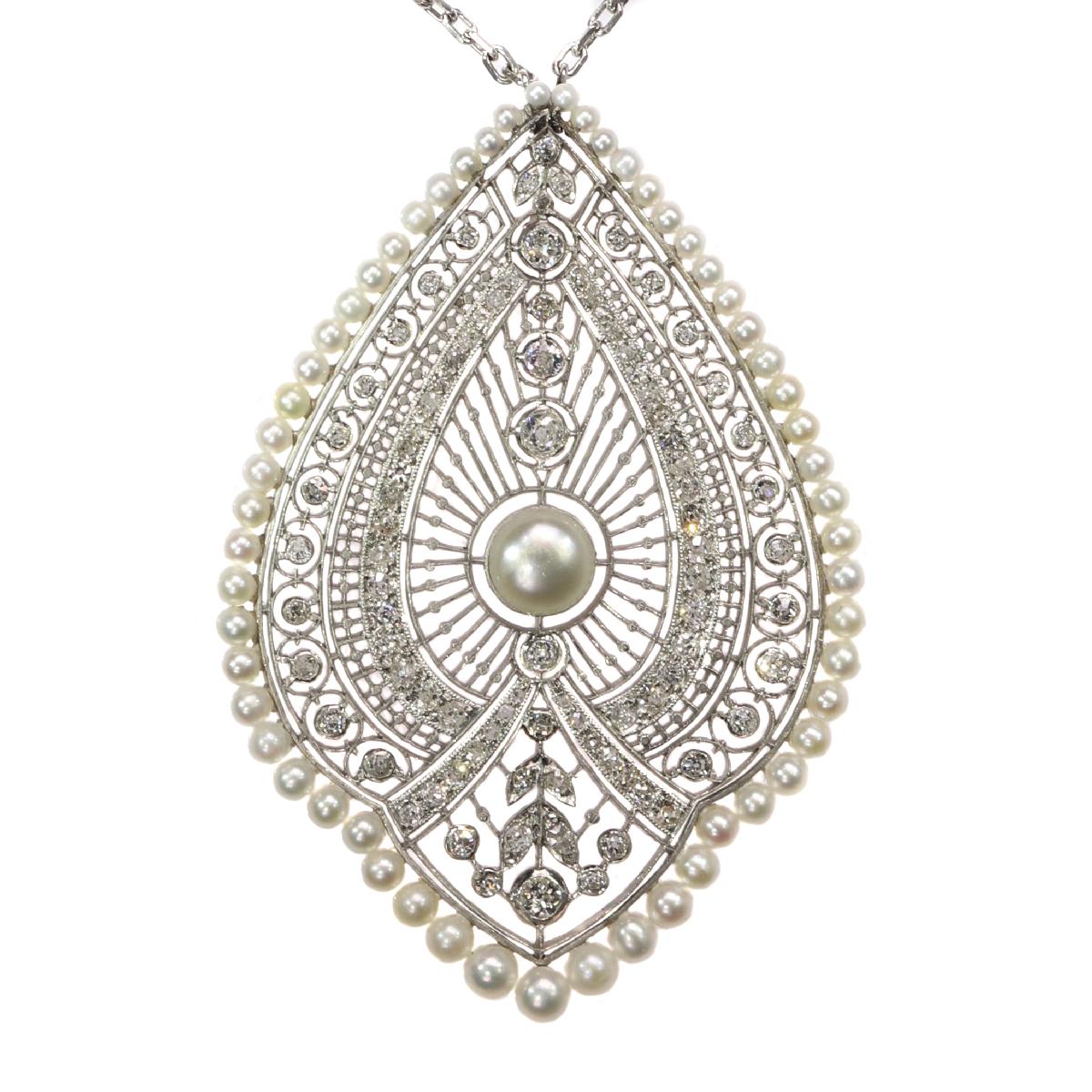 Everyone's astonishment at this princess necklace with a platinum peacock plume pendant out of typical Edwardian hand-sawn lace is indescribable. Its intricate craftsmanship radiates from the central natural orient pearl over alternating halos of 96
