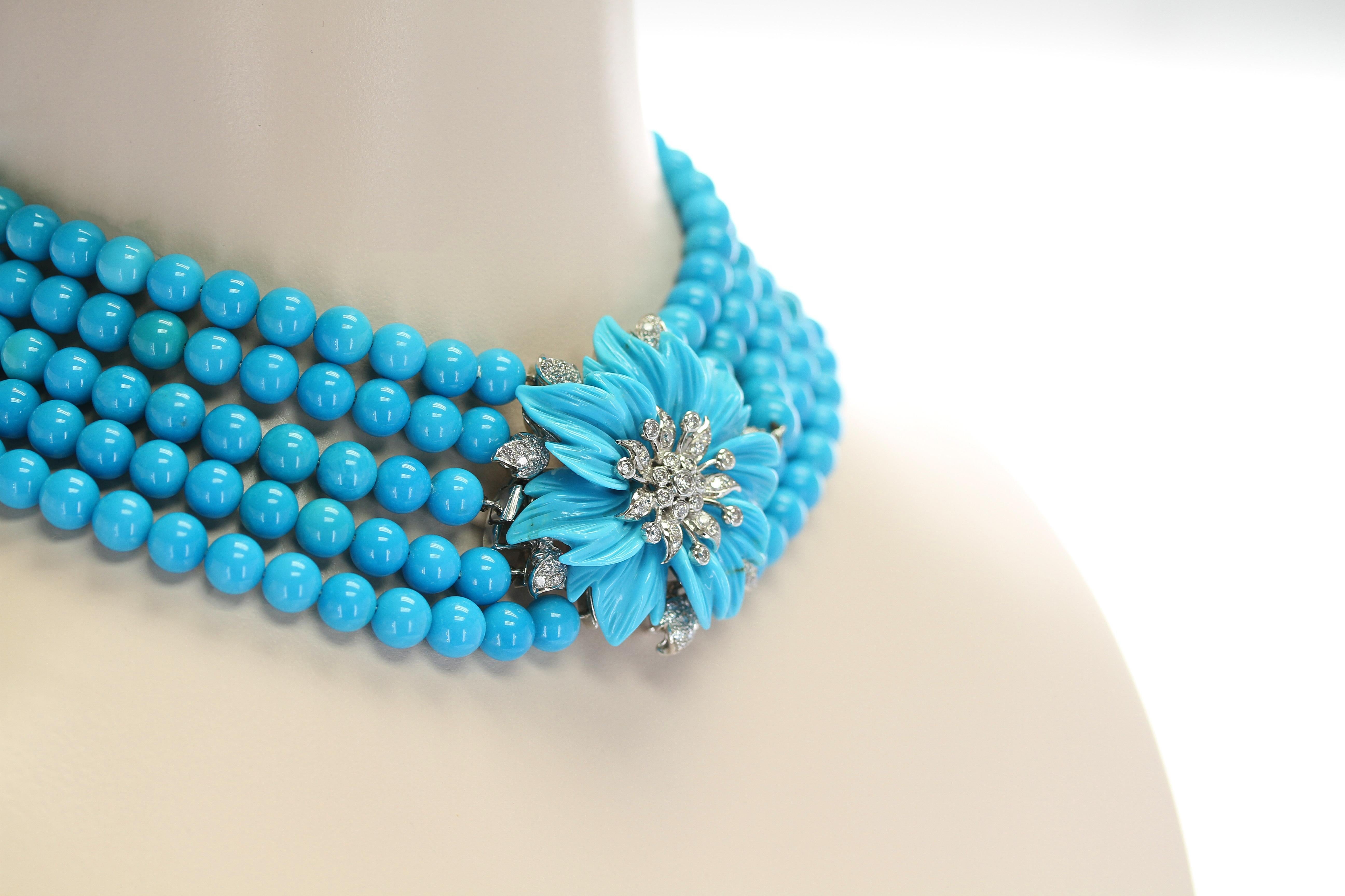 A stunning and artistic choker necklace consisting of five strand of genuine, 8mm beautiful blue turquoise strands attached to a unique floral carved turquoise set with a spray of round, brilliant-cut diamonds in 18kt white gold; stamped 750 with