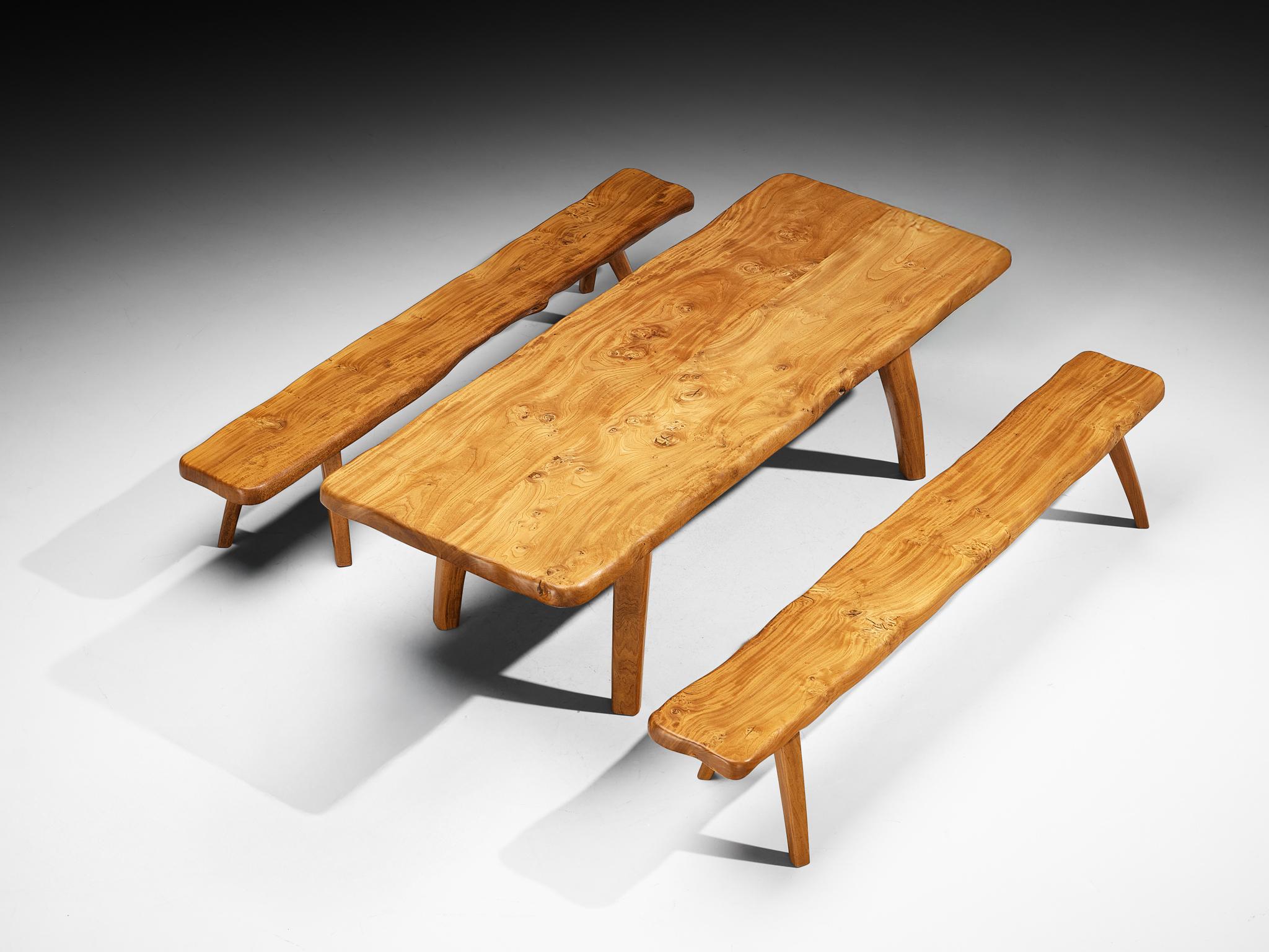 Dining table, solid elm, France, 1970s/80s

This French dining table from the 1970s-80s expresses a naturalistic character. A thick  free form shaped wooden slab is characterized by free flowing edges. Four splayed legs give the table a stable,