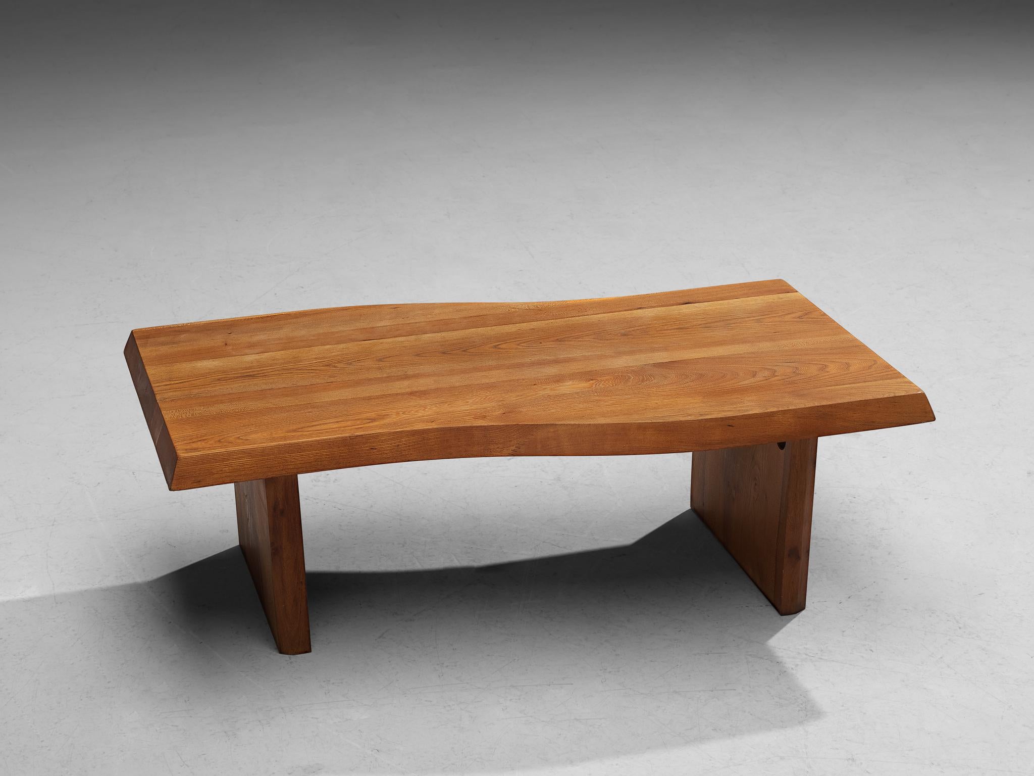 Coffee table, elm, France, 1970s 

The top of this wonderful coffee table is hand carved from an elm tree slab. While the top convinces with its natural and dynamic appearance due to the organic, free flowing edges, the base is expressed through