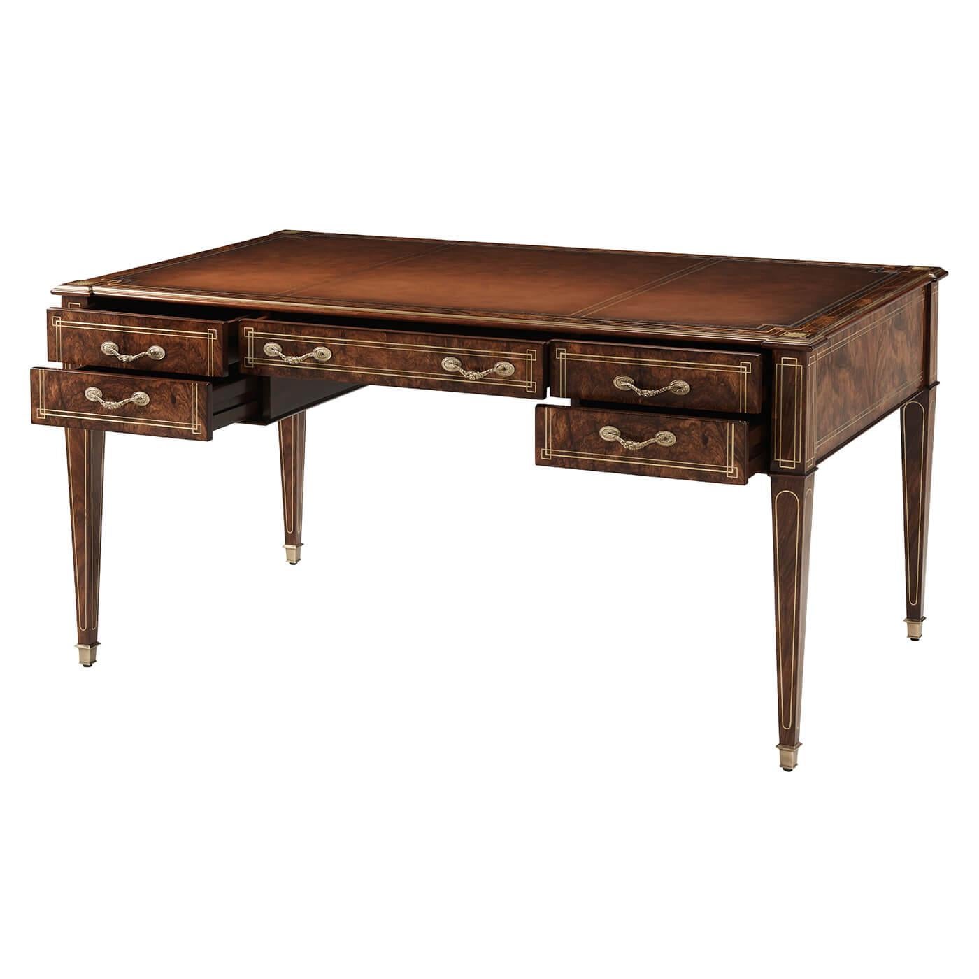 A French neoclassic style Bureau Plat with a gilt-tooled inset leather top writing surface, with exotic Zebrali veneers, with five drawers, fine brass inlays, raised on brass inlaid square tapered legs and square brass sabots.

Dimensions: 60