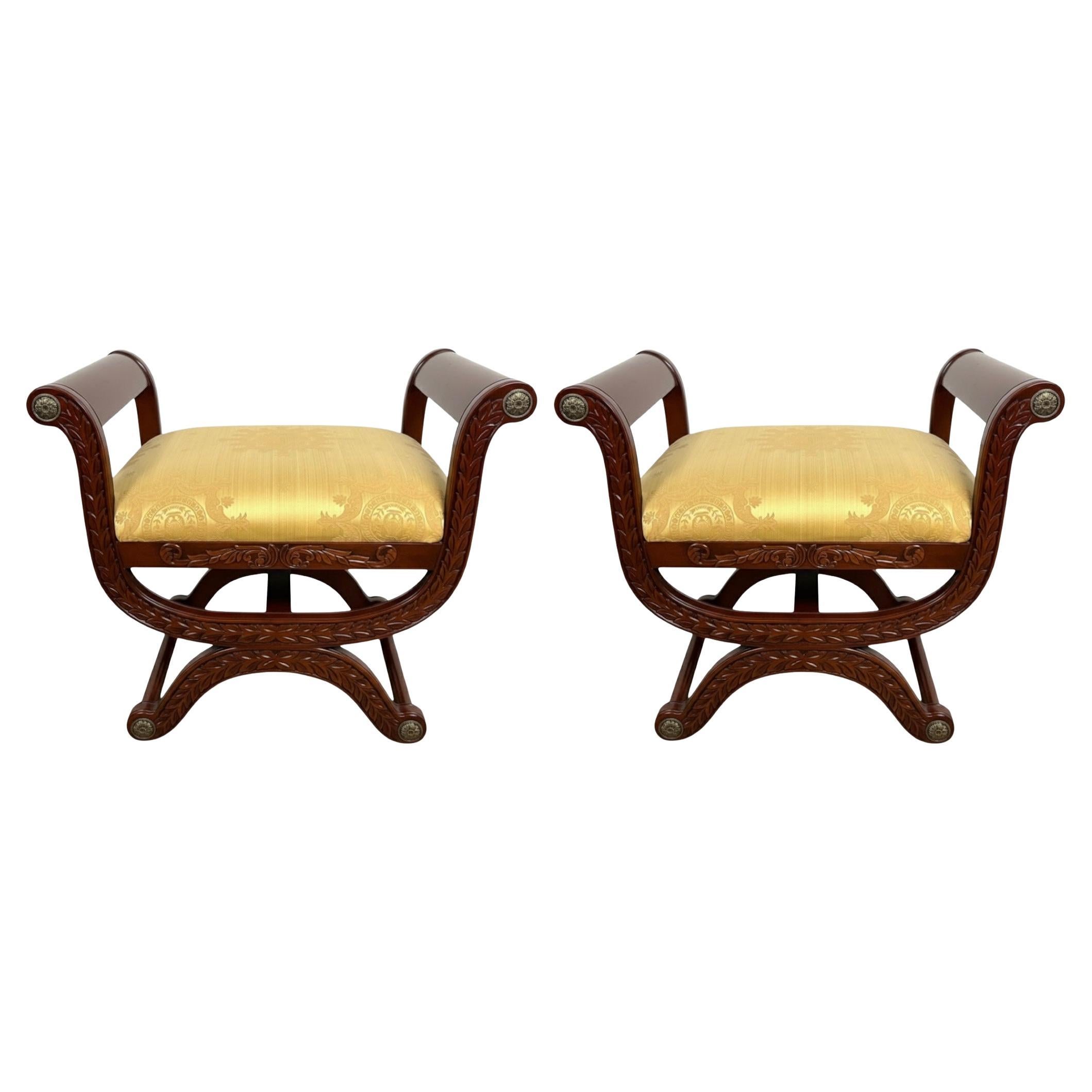 This is a pair of French neo-classical style x base benches. They have a nice large scale. The caps appear to be bronze. The yellow upholstery is in nice condition. They are unmarked and most likely date to the later part of the 20th century. 