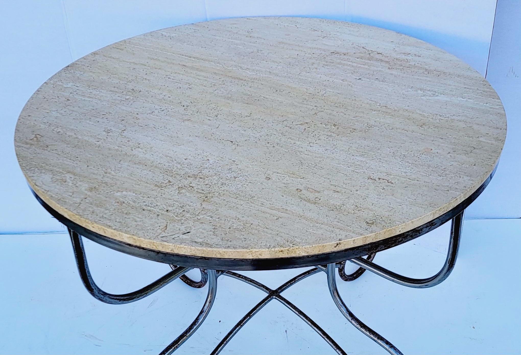 This is a French neo-classical style steel, brass and stone center or dining table. It’s clean lined make it a very versatile piece. It could be used as a small dining or center table. The frame is steel and brass, with a removable stone top. It is