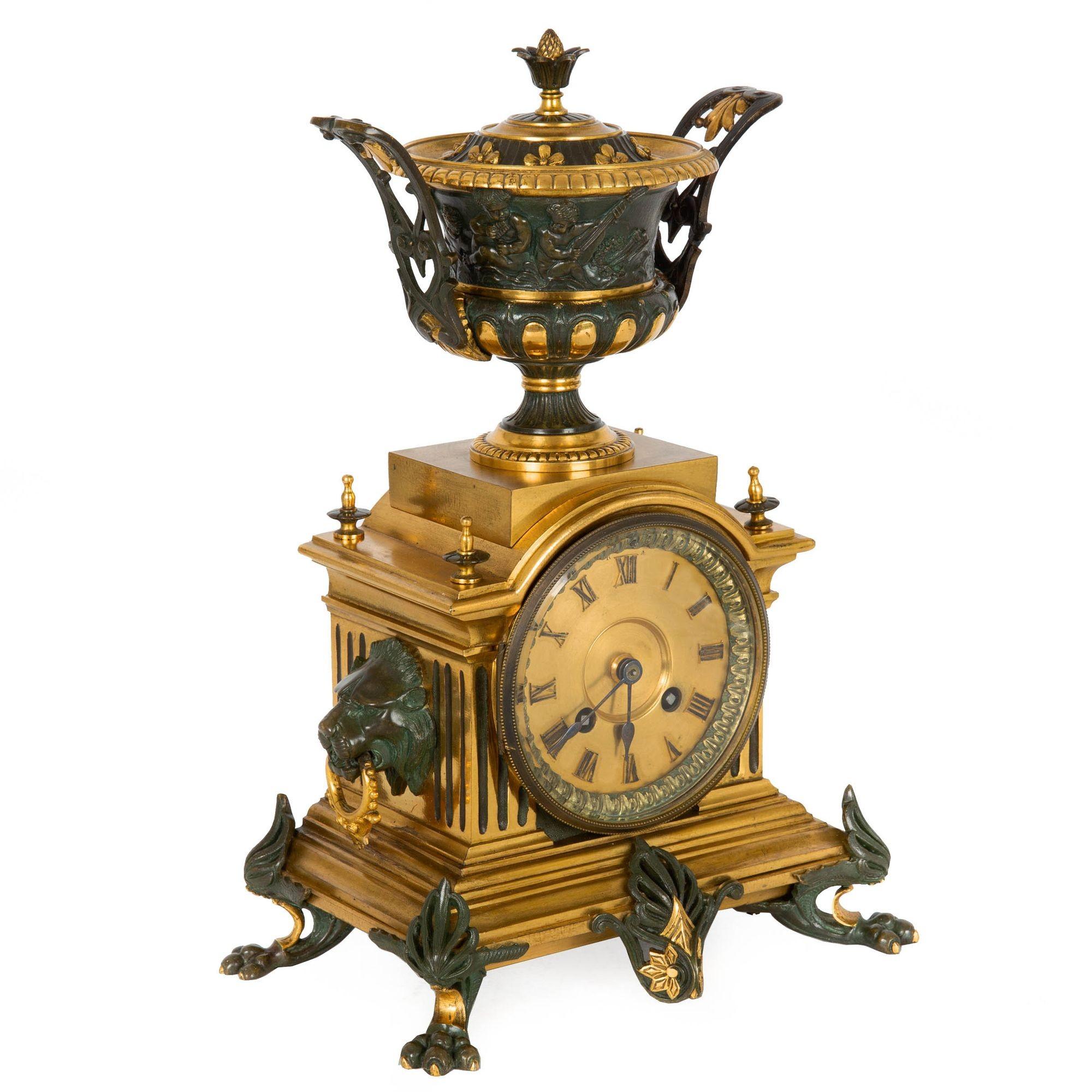 A beautifully cast, chiseled and chased Napoleon III period mantel clock executed in the Neo-Grec taste, the case is surmounted by an urn with exquisitely detailed relief Bacchanalia scenes complete with its lid. The face is covered in a thick