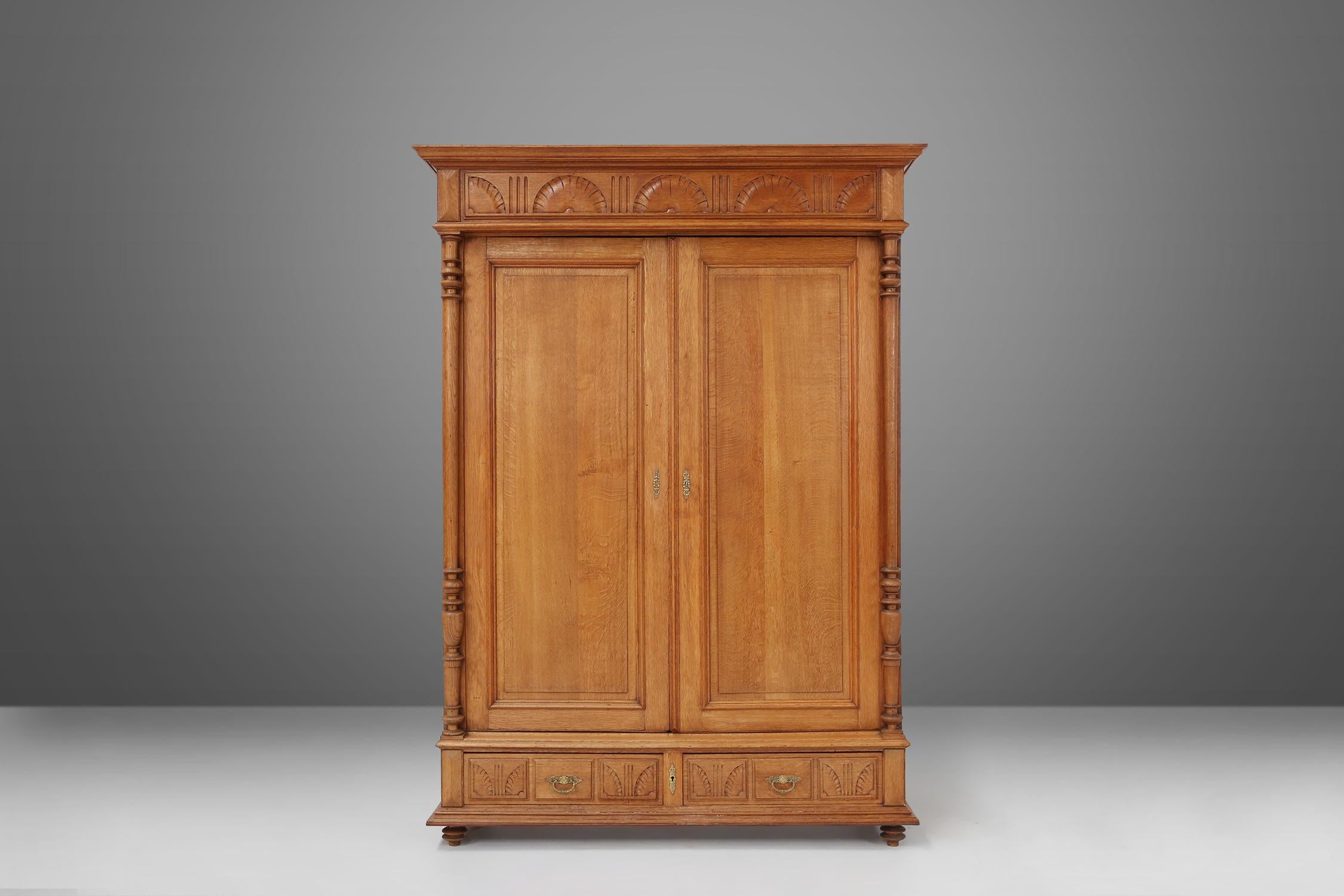 This stunning antique wooden wardrobe with two doors and two drawers is a true masterpiece. Crafted with meticulous attention to detail, this neo-renaissance armoire showcases the timeless beauty of wooden furniture. The rich, warm tones of the wood