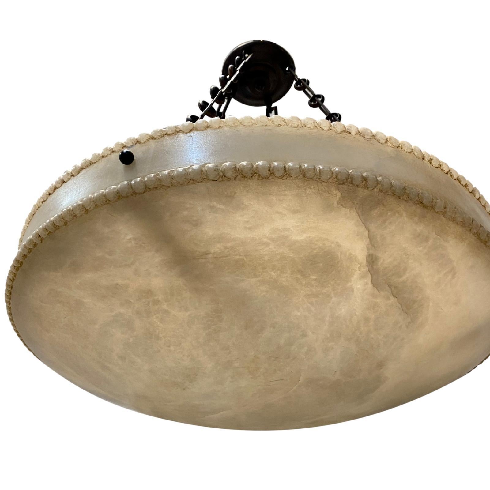A circa 1960's French neoclassic style carved alabaster light fixture.

Measurements:
Current drop: 24