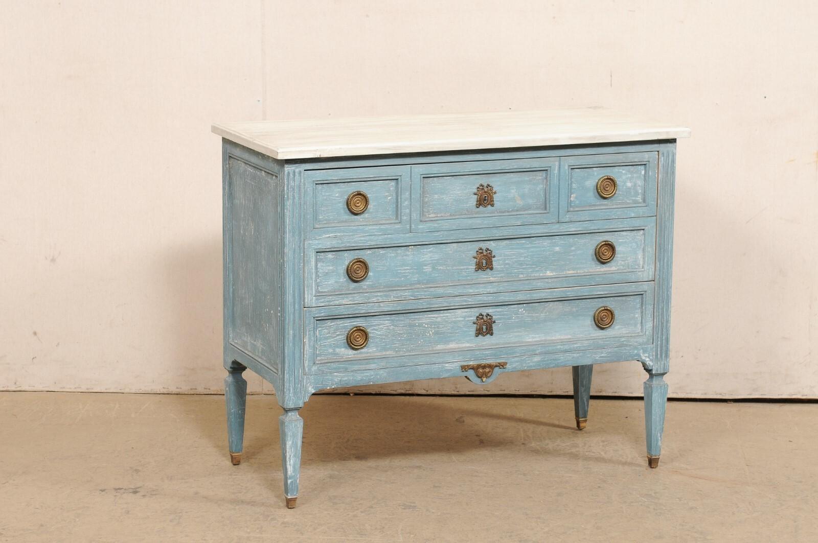 A French Neoclassical style painted wood commode from the mid 20th century. This mid-century chest from France features a rectangular-shaped top, which rests above a neoclassical style case that houses three full-sized drawers flanked within
