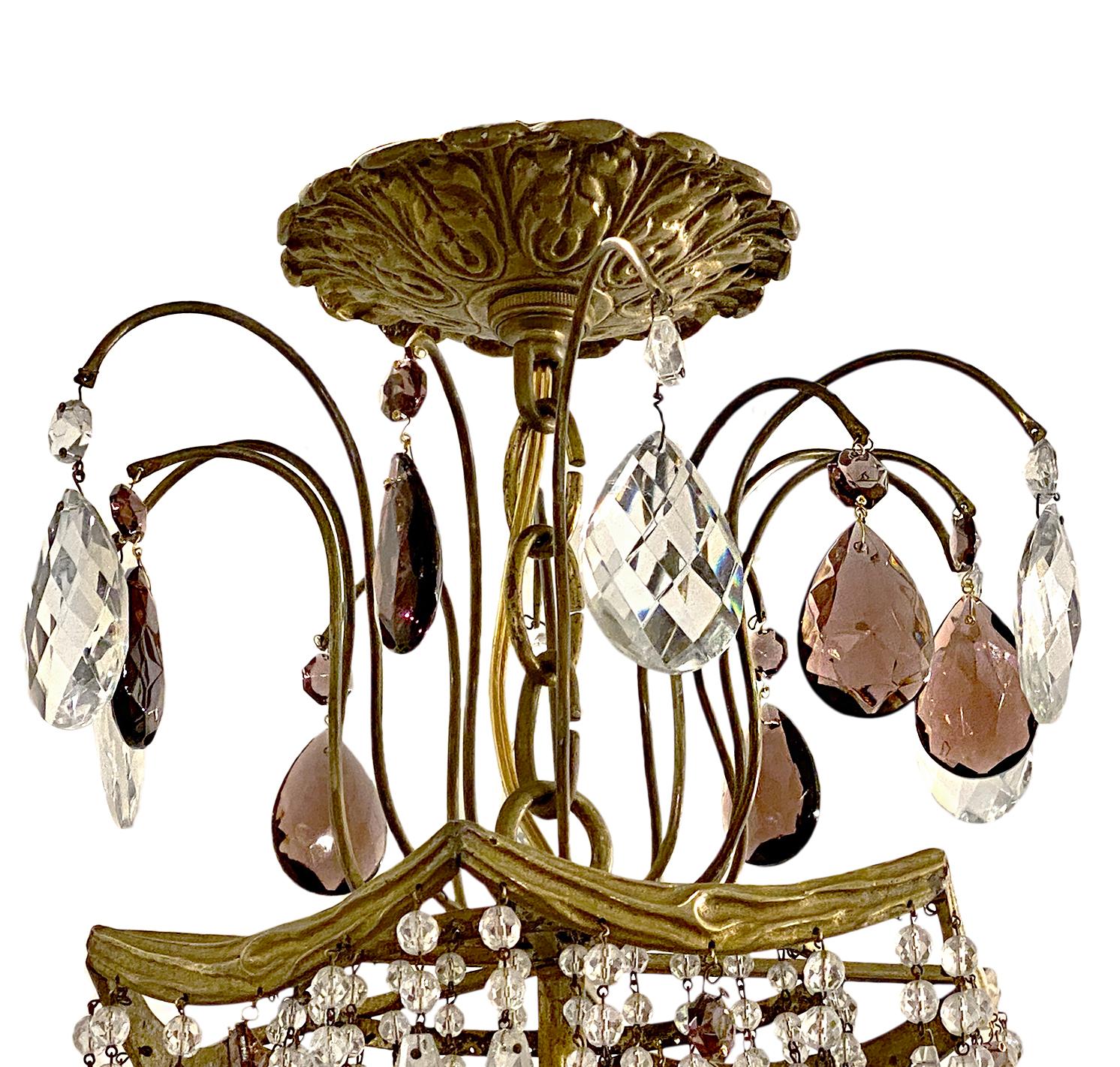 A late 19th century French chandelier with original gilt finish, swags of bronze forming the body, crystal beads chains and amethyst crystals.

Measurements:
Height 40