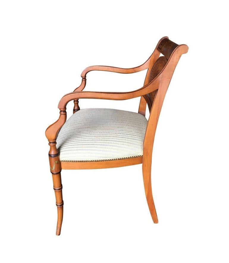 The French neoclassic dining chair exudes elegance with its hand-painted floral woven wicker back, marrying sophistication and nature-inspired charm. Its sculpted legs add grace and stability, making it a timeless piece that beautifully blends