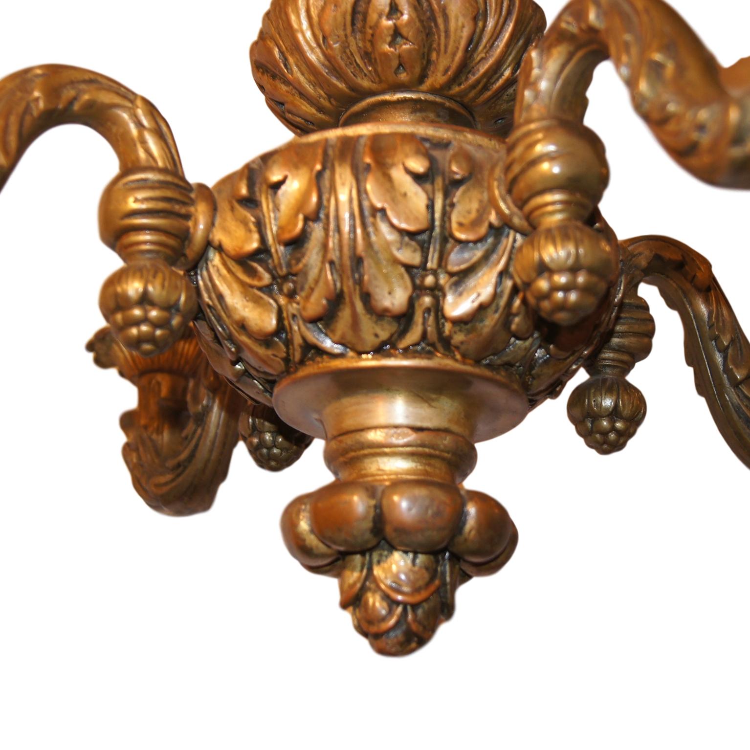 A circa 1920s French gilt plaster and wood neoclassic chandelier with original patina.

Measurements:
Height (adjustable) 29