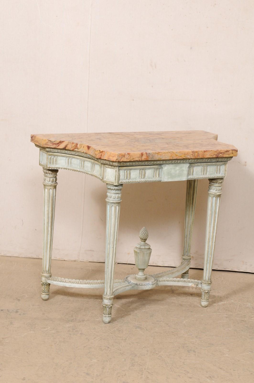 A French Neoclassical console table with its original marble top from the early 19th century. This antique table from France retains its original marble top, with a shorter straight mid section at front, which flows nicely to curvy sides, and join