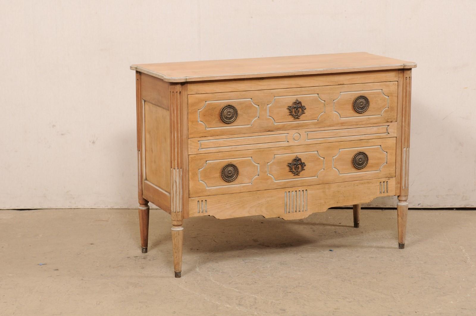 A French-style raised carved-wood chest of drawers. This vintage commode from American furniture maker 