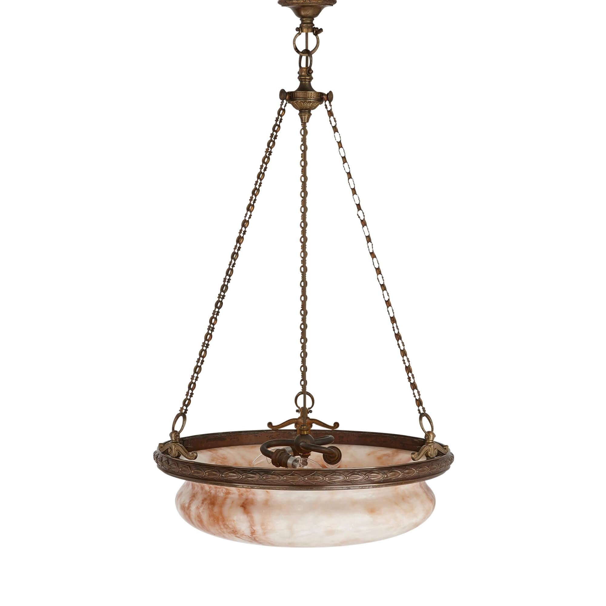 French neoclassical bronze and alabaster chandelier
French, early 20th Century
Measures: Height 100cm, diameter 53cm

The chandelier is crafted from veined alabaster and bronze in the Neoclassical style. The piece features an alabaster bowl,