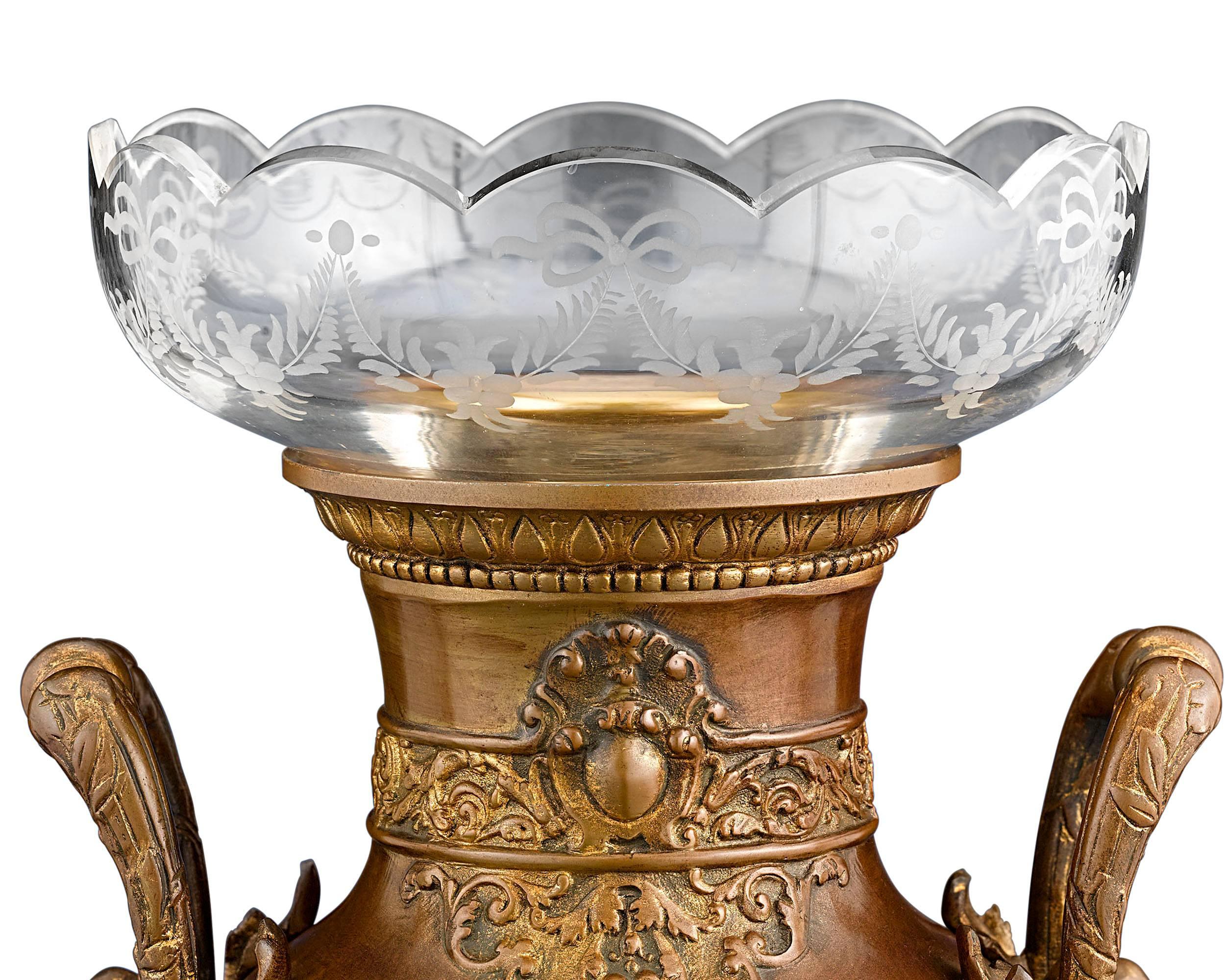 A striking mythological motif distinguishes this outstanding pair of French Neoclassical gilt bronze urns. Modeled after a design by French architect Léon Boucher, these magnificent, baluster-form vases display exceptional images of Greek heroes