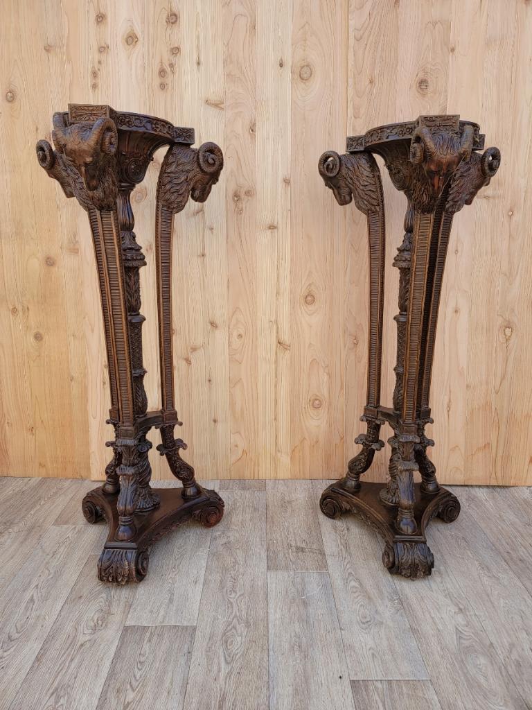 Vintage French Neoclassical finely carved mahogany finished Ram's head pedestal stands - pair.

Exquisite and stunning large pair of French Neoclassical, finely carved, mahogany finished, ram's head heavy statue pedestals or plant stands.