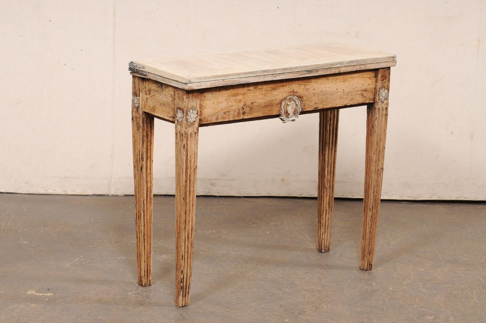 A French Neoclassical carved-wood console table, with expandable flip-top, from the 19th century. This antique table from France has a rectangular-shaped top that can be flipped and slid open so that the size doubles and the table top becomes a more
