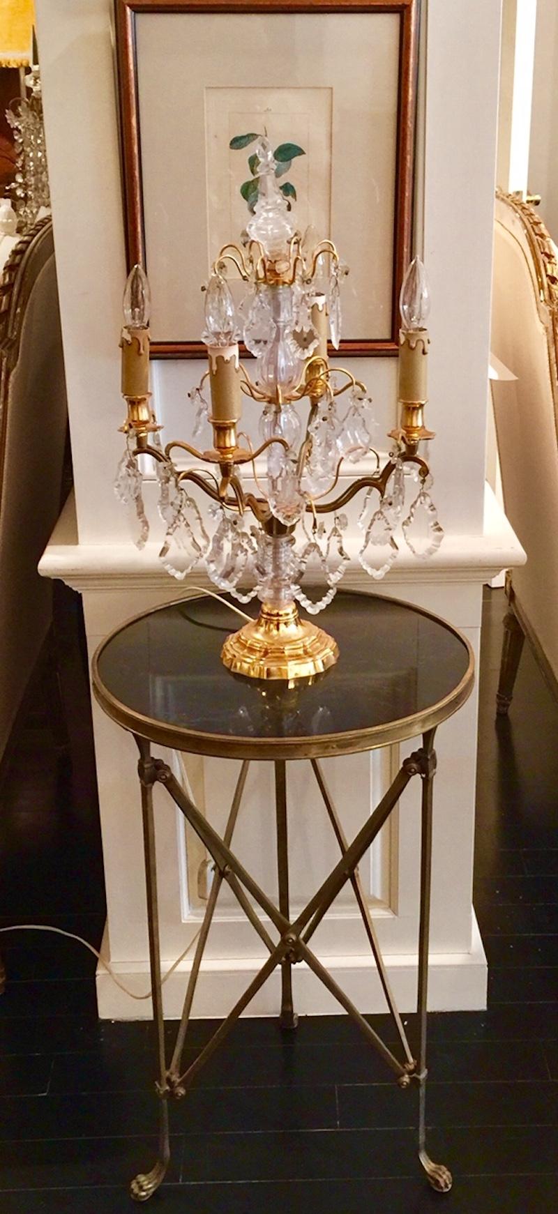 A classic French bronze and black marble round gueridon table on slendor legs with paw feet. A round black marble top is encircled by a decorative bronze band. The legs are joined by an openwork triangular bronze crosspiece. 

Dimension: 16.75 in